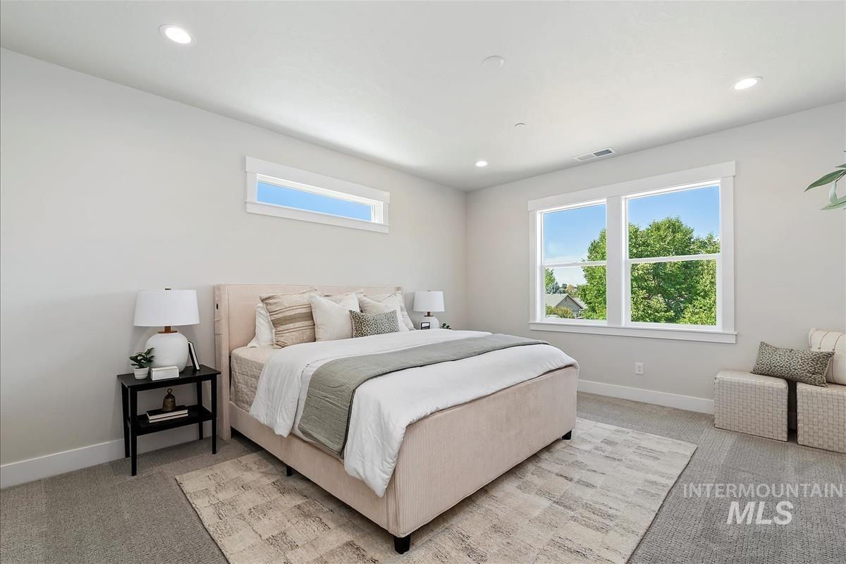 Bedroom with light carpet and recessed lighting
