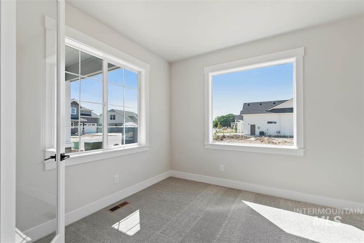 Unfurnished room with carpet and healthy amount of natural light