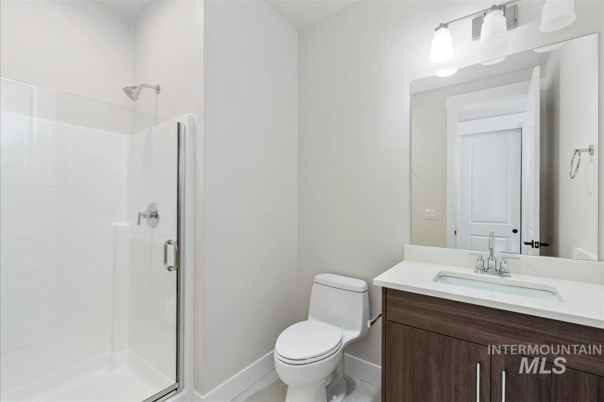 Bathroom featuring a shower stall and vanity