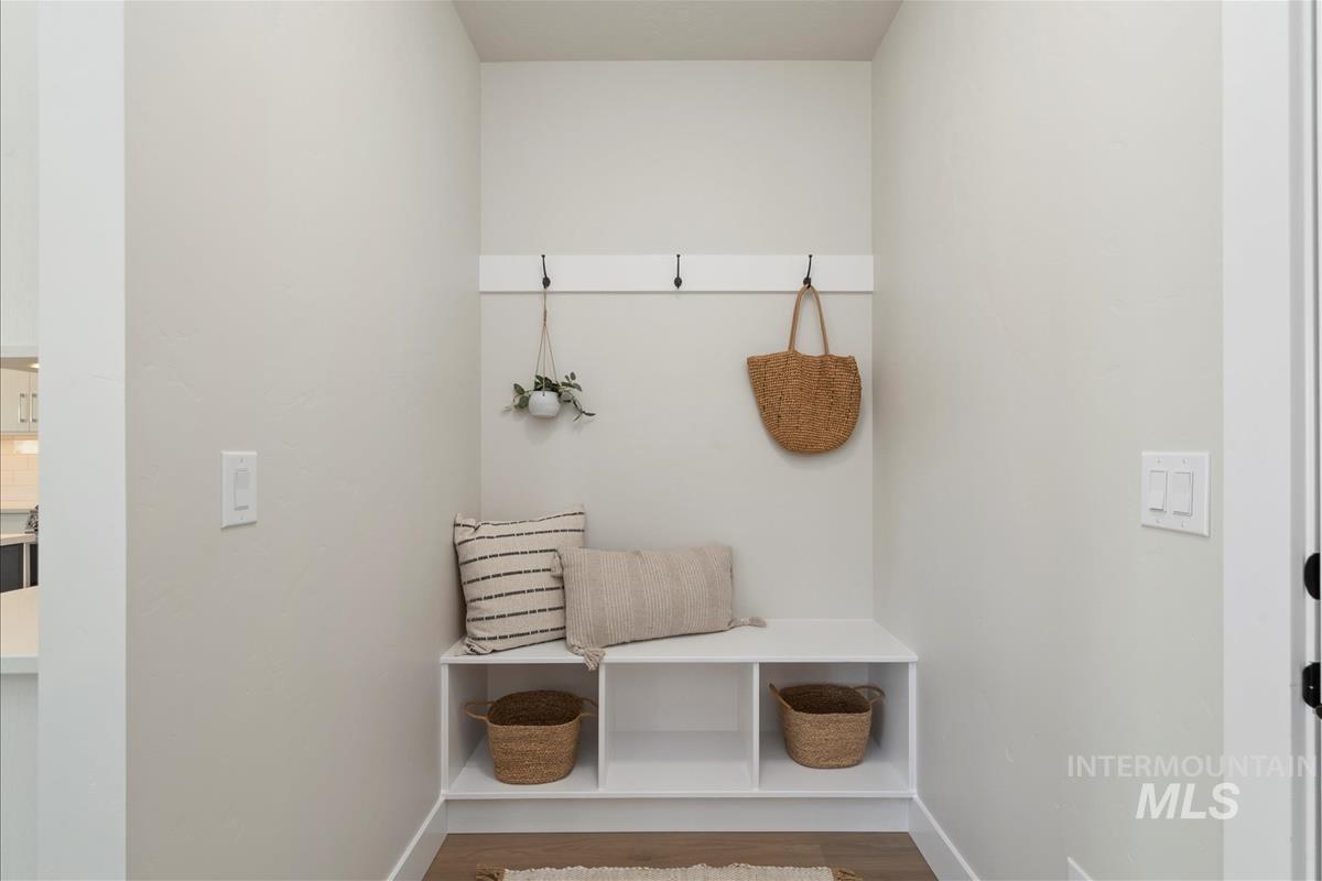 Mudroom featuring baseboards and wood finished floors