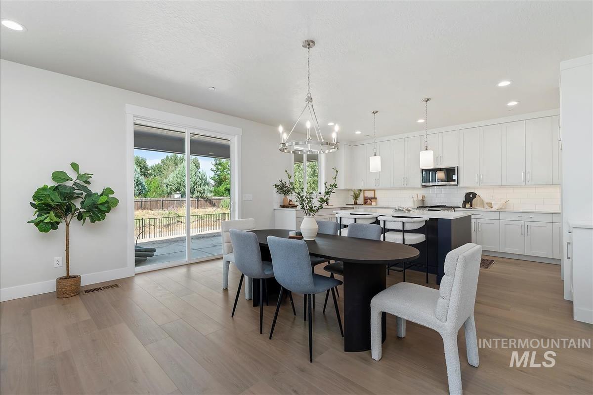 Dining room featuring recessed lighting, a chandelier, and light wood-style floors