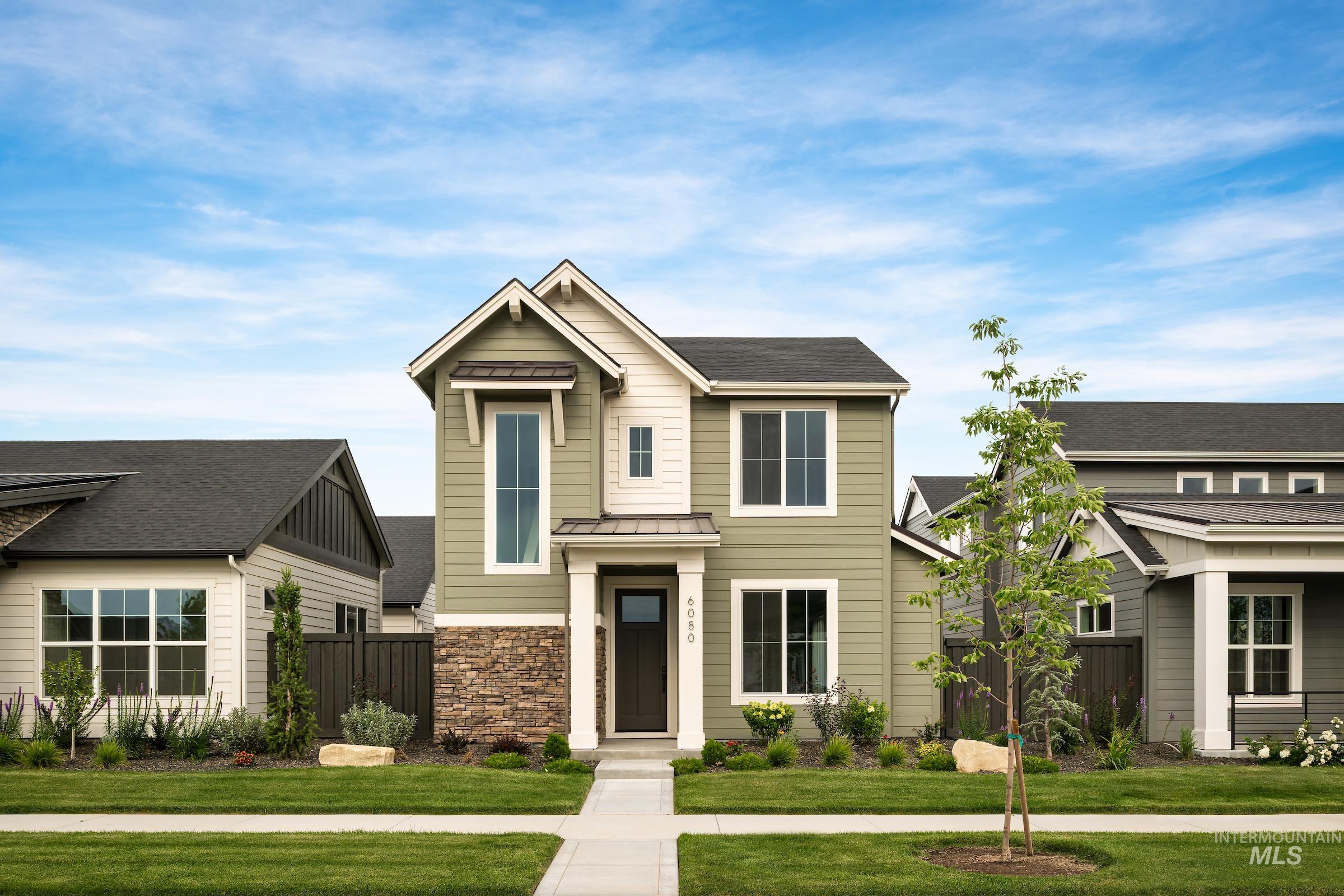 Craftsman inspired home featuring a standing seam roof, a metal roof, and a shingled roof