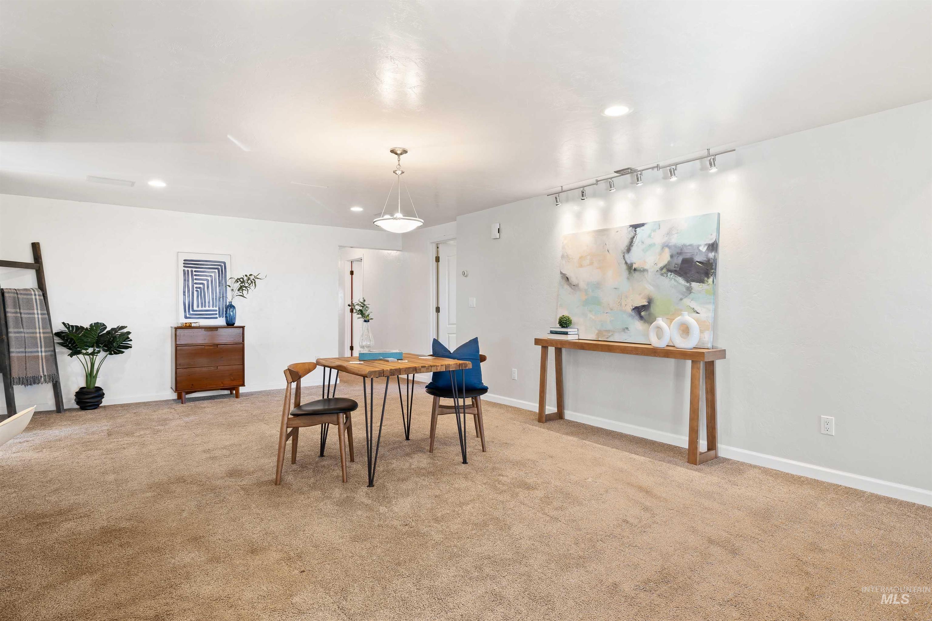 Dining area featuring light carpet and recessed lighting