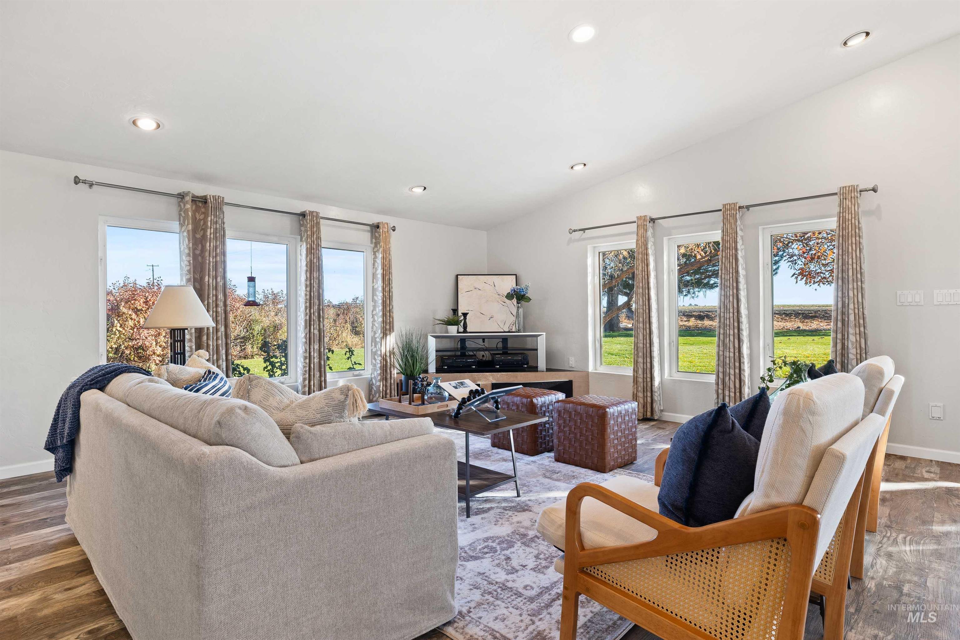 Living room featuring recessed lighting, vaulted ceiling, and dark wood finished floors