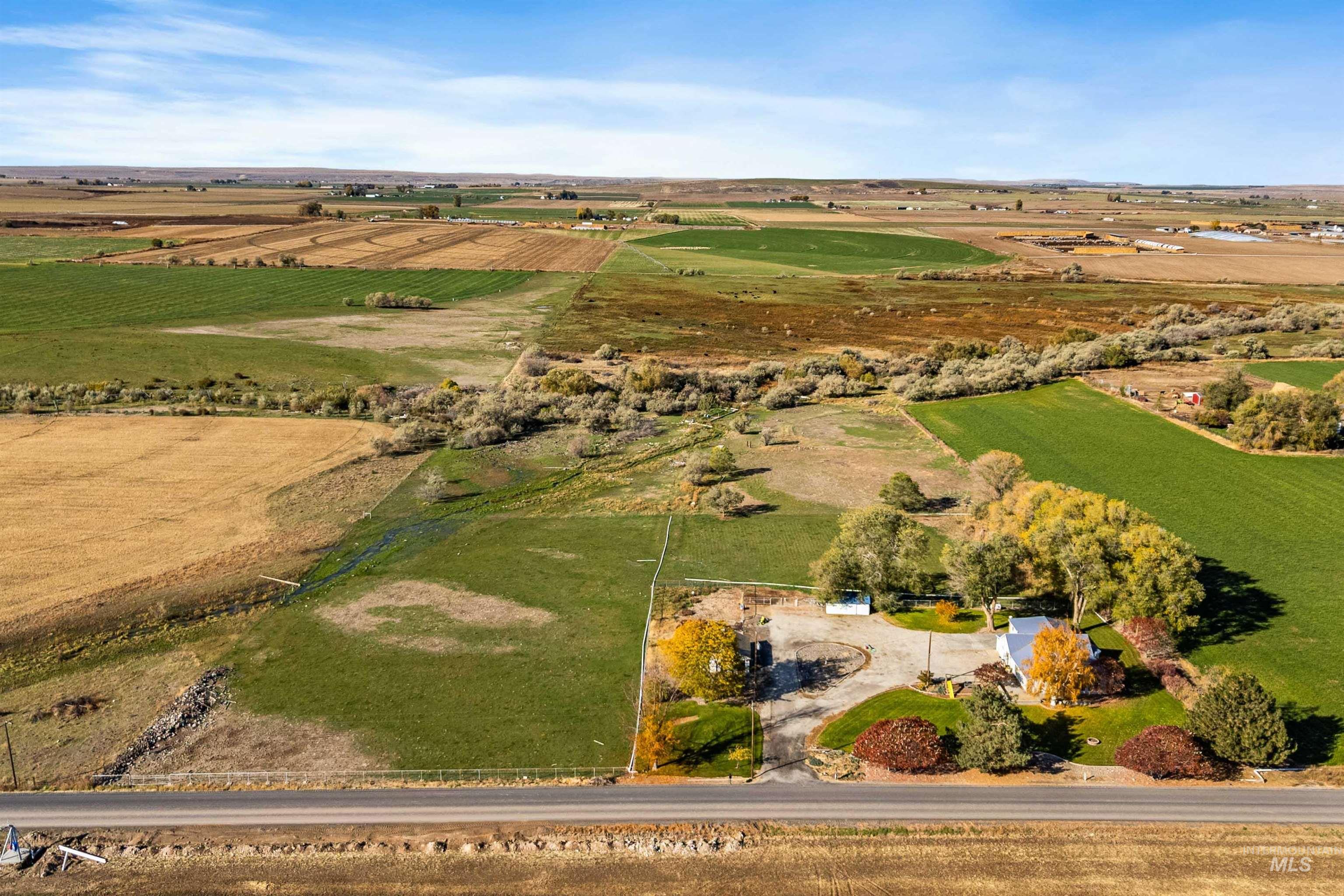 Aerial overview of property's location with rural landscape and farmland