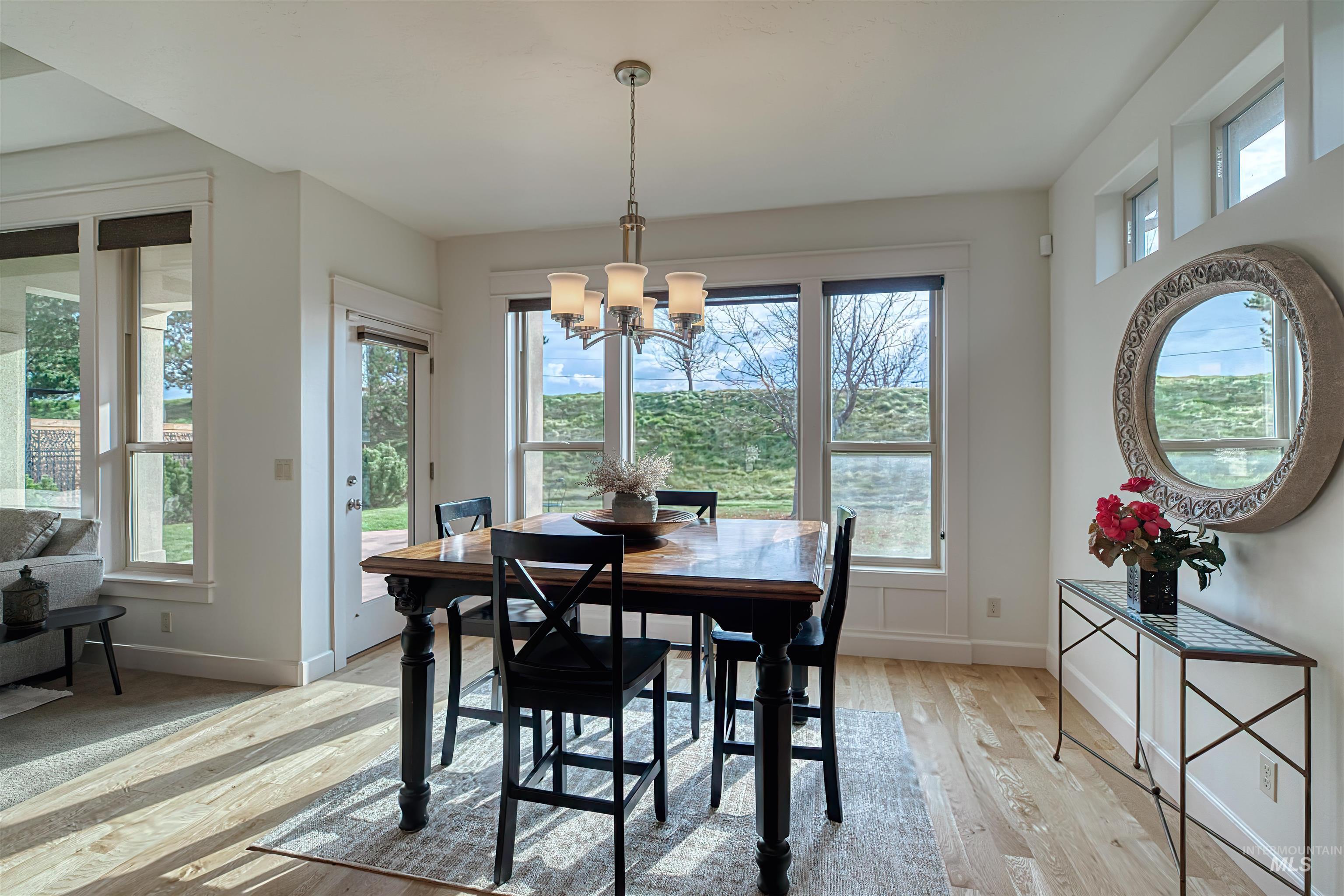 Dining space with light wood-style flooring and a chandelier
