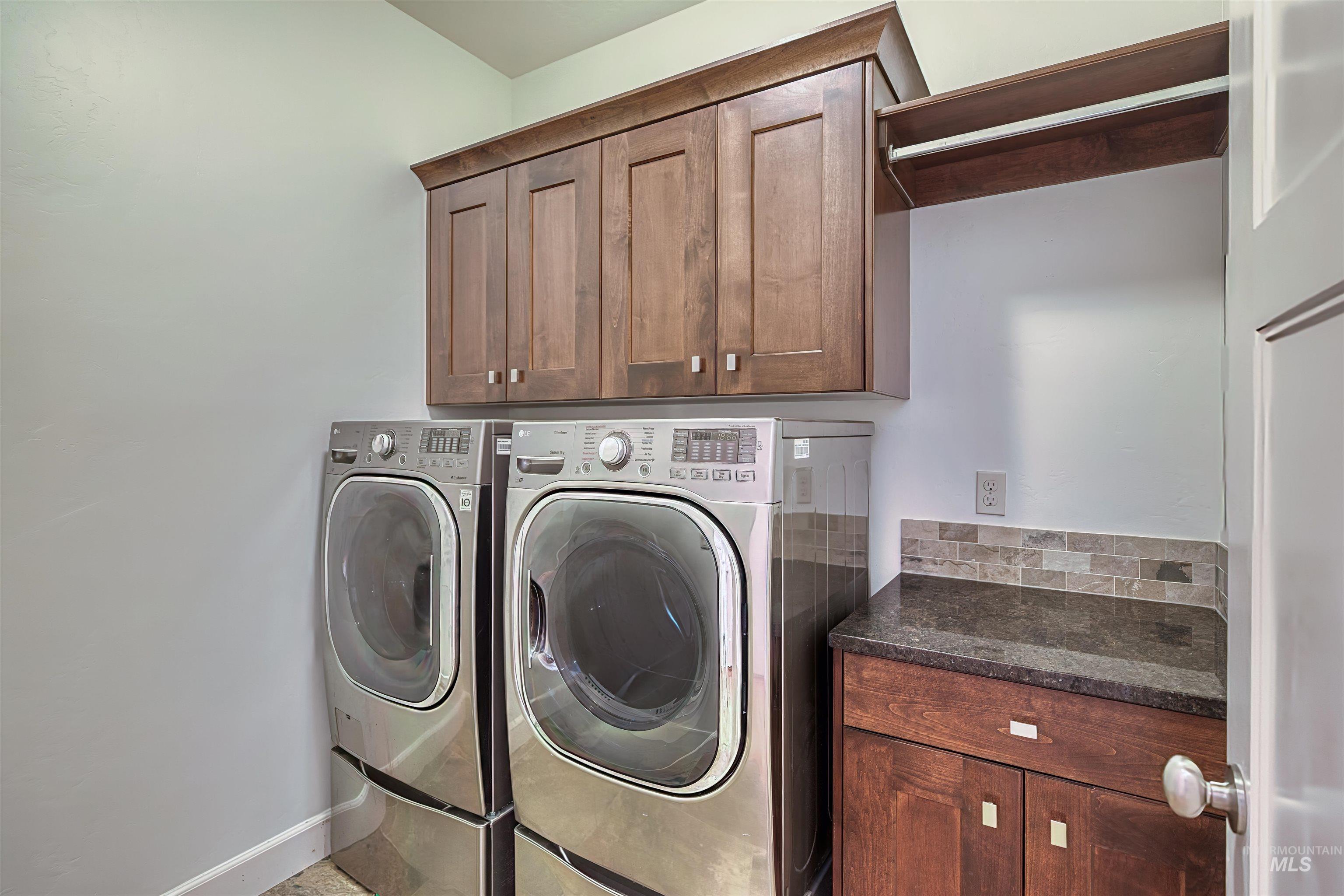 Laundry area with washer and dryer and cabinet space