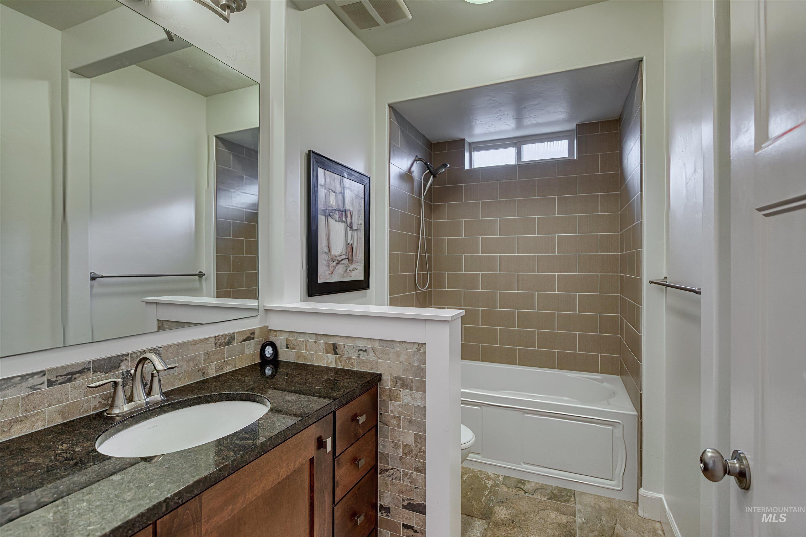 Bathroom featuring vanity and tub / shower combination