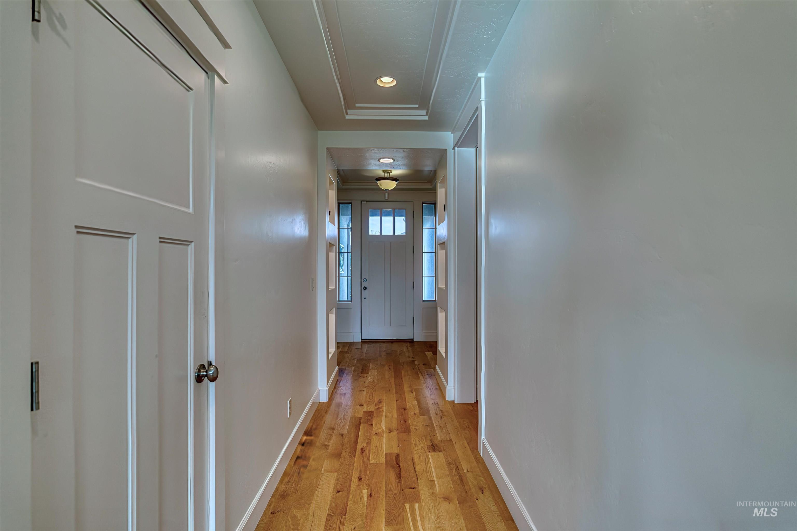 Hallway featuring light wood finished floors and recessed lighting