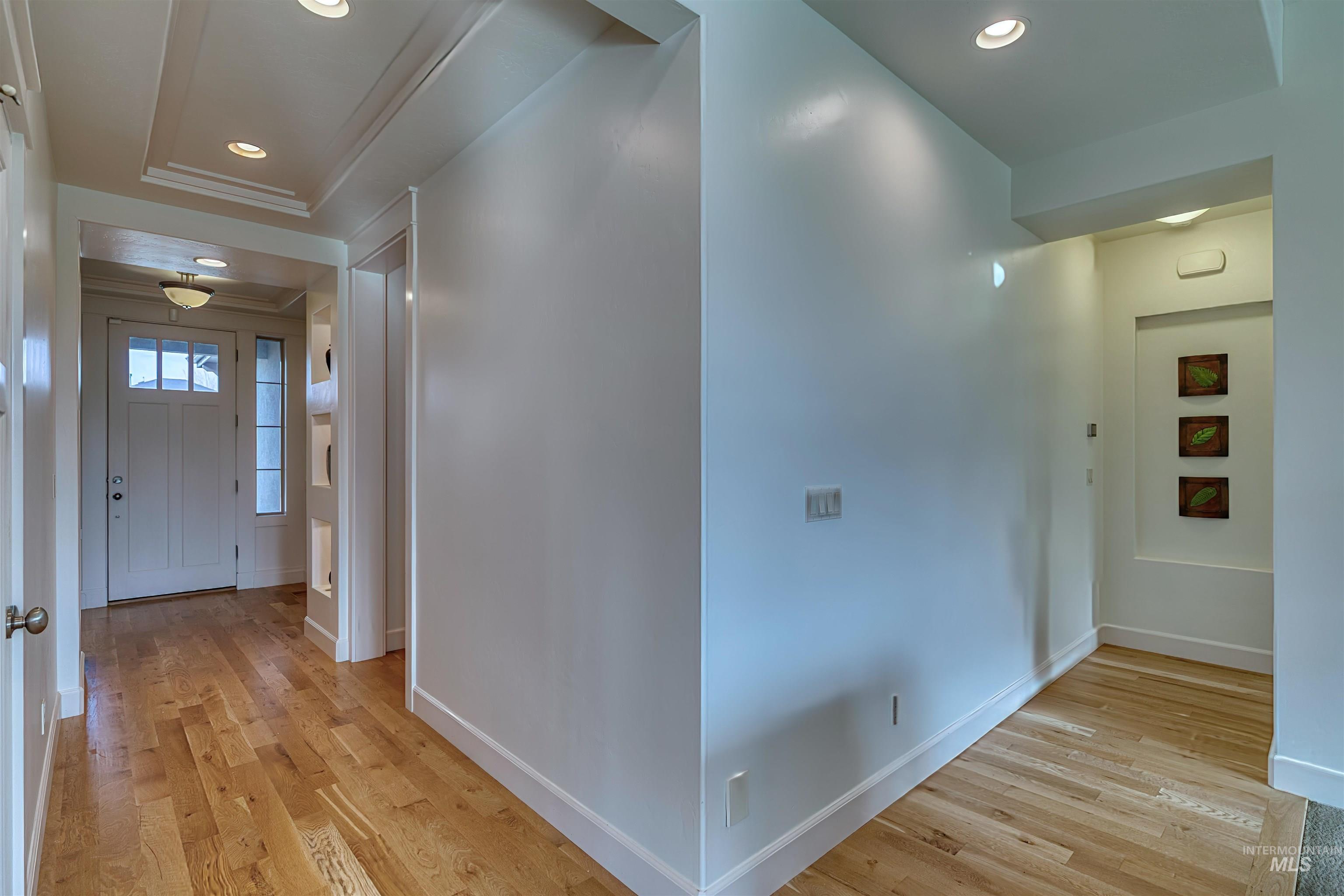 Hall featuring light wood-type flooring and recessed lighting