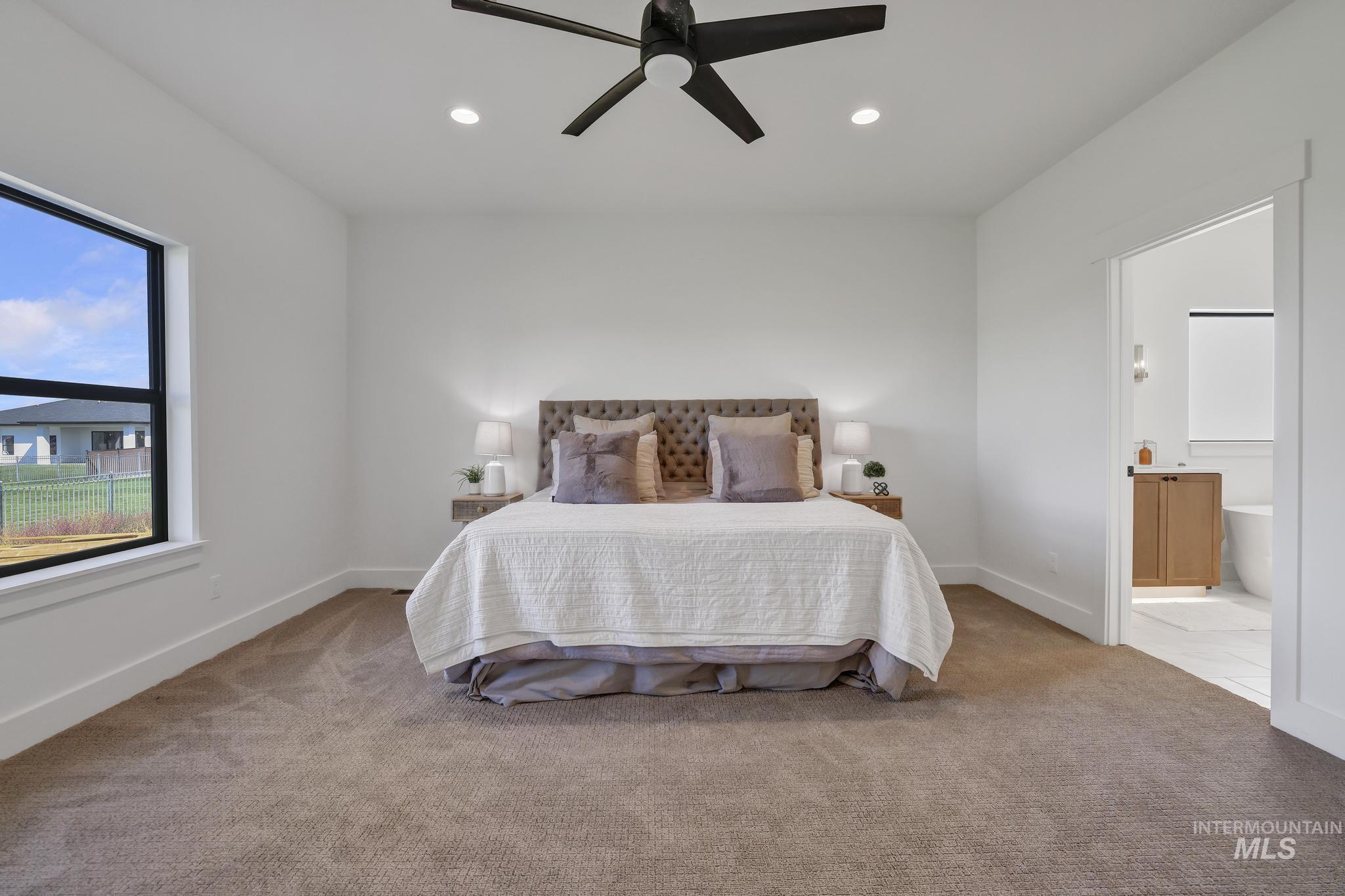 Bedroom featuring light carpet, recessed lighting, ensuite bathroom, and ceiling fan
