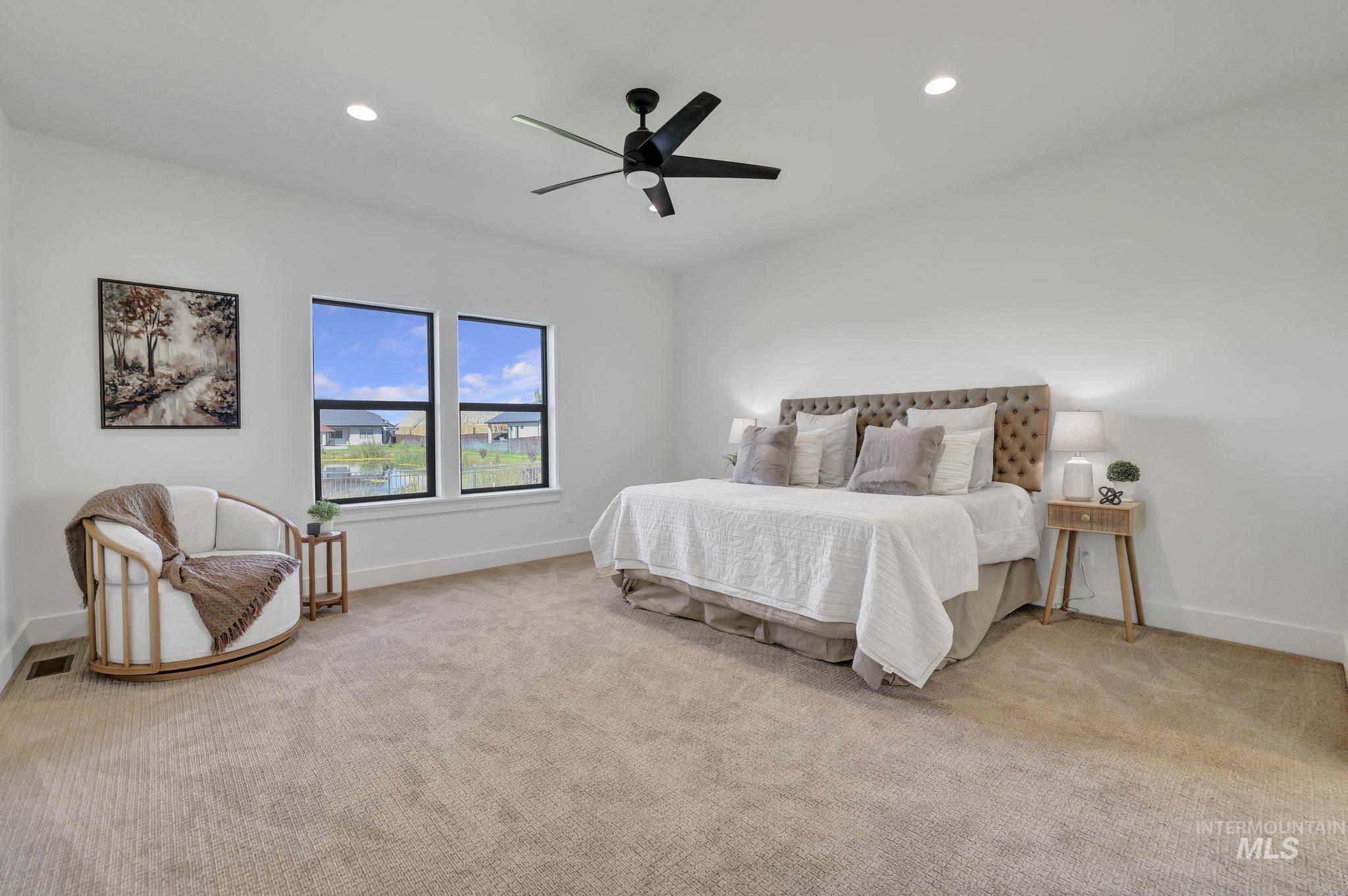 Bedroom featuring light carpet, recessed lighting, and ceiling fan
