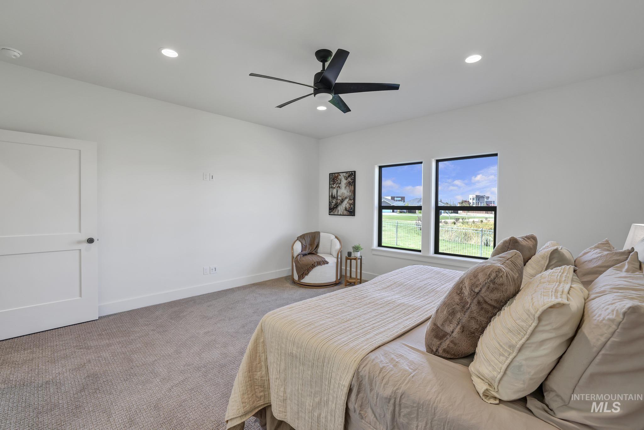 Carpeted bedroom with recessed lighting and ceiling fan