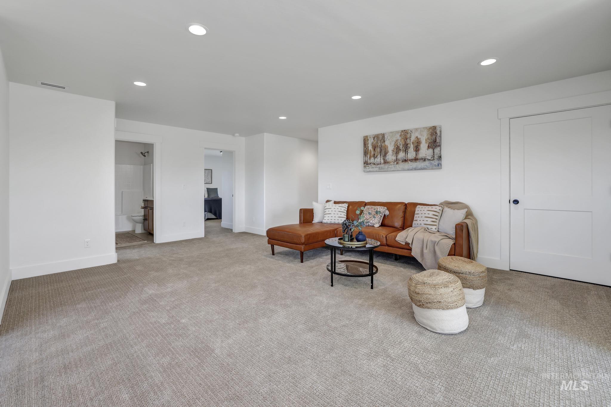 Carpeted living room featuring recessed lighting