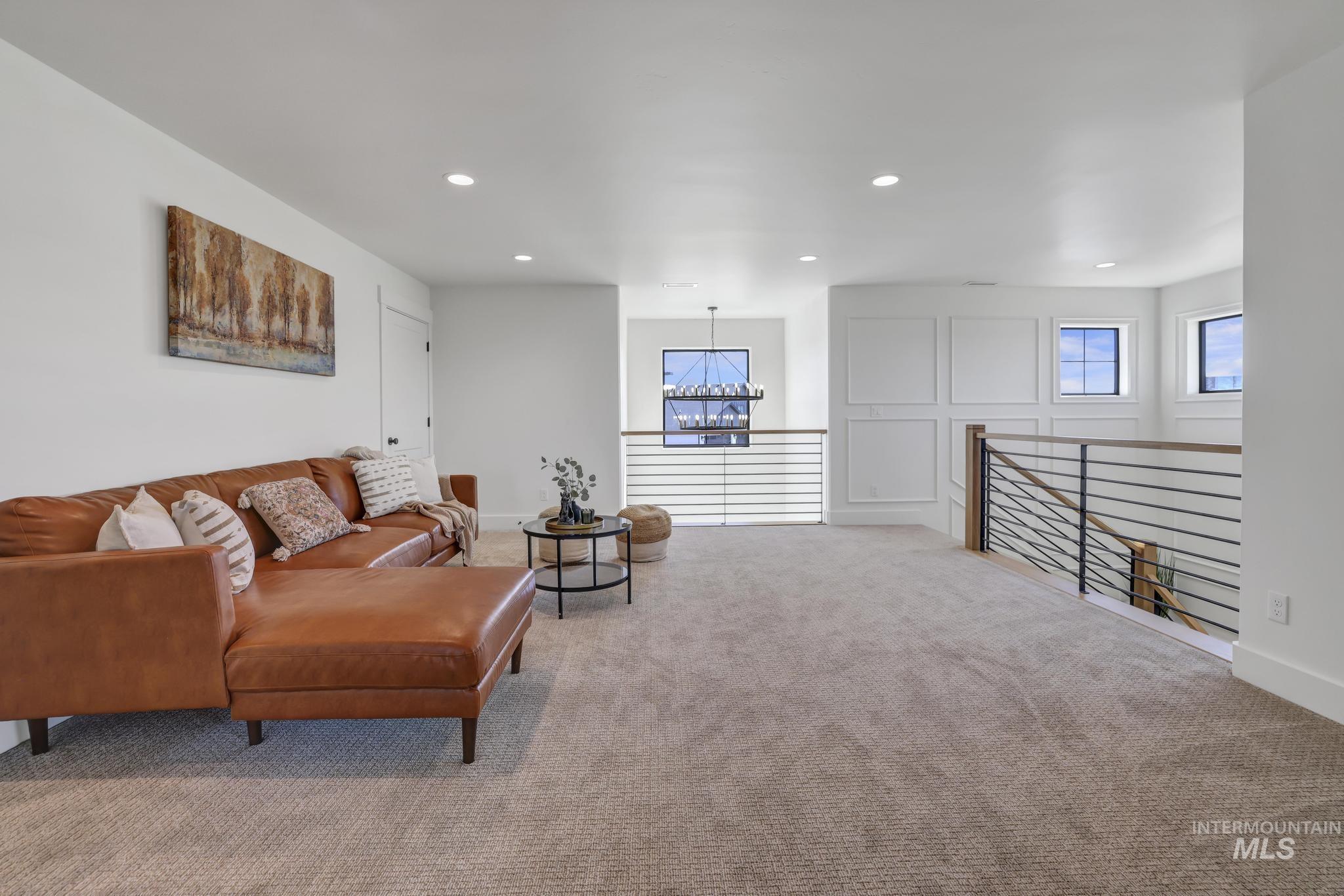 Living area featuring carpet floors, recessed lighting, and a chandelier
