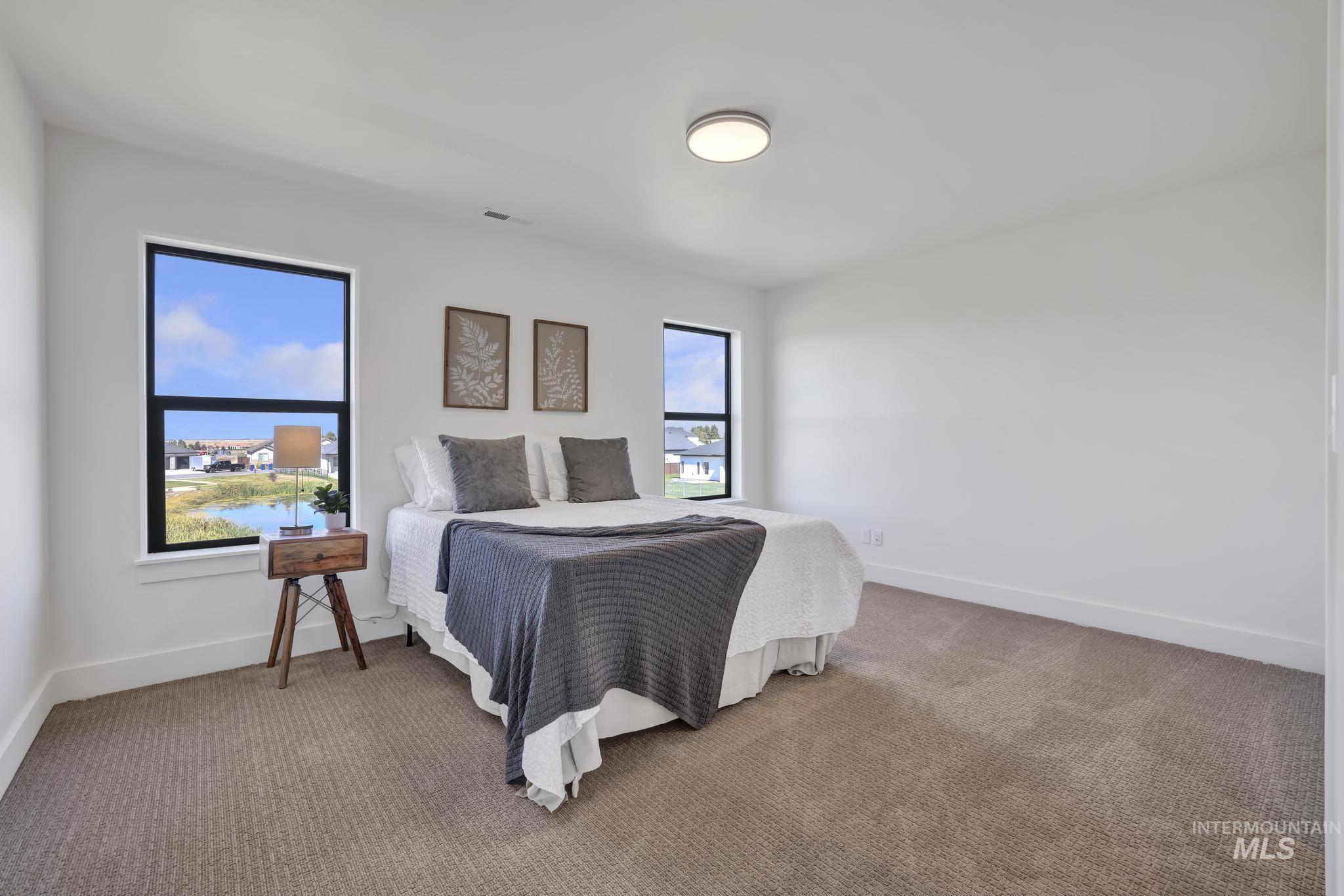 Bedroom with carpet floors and baseboards