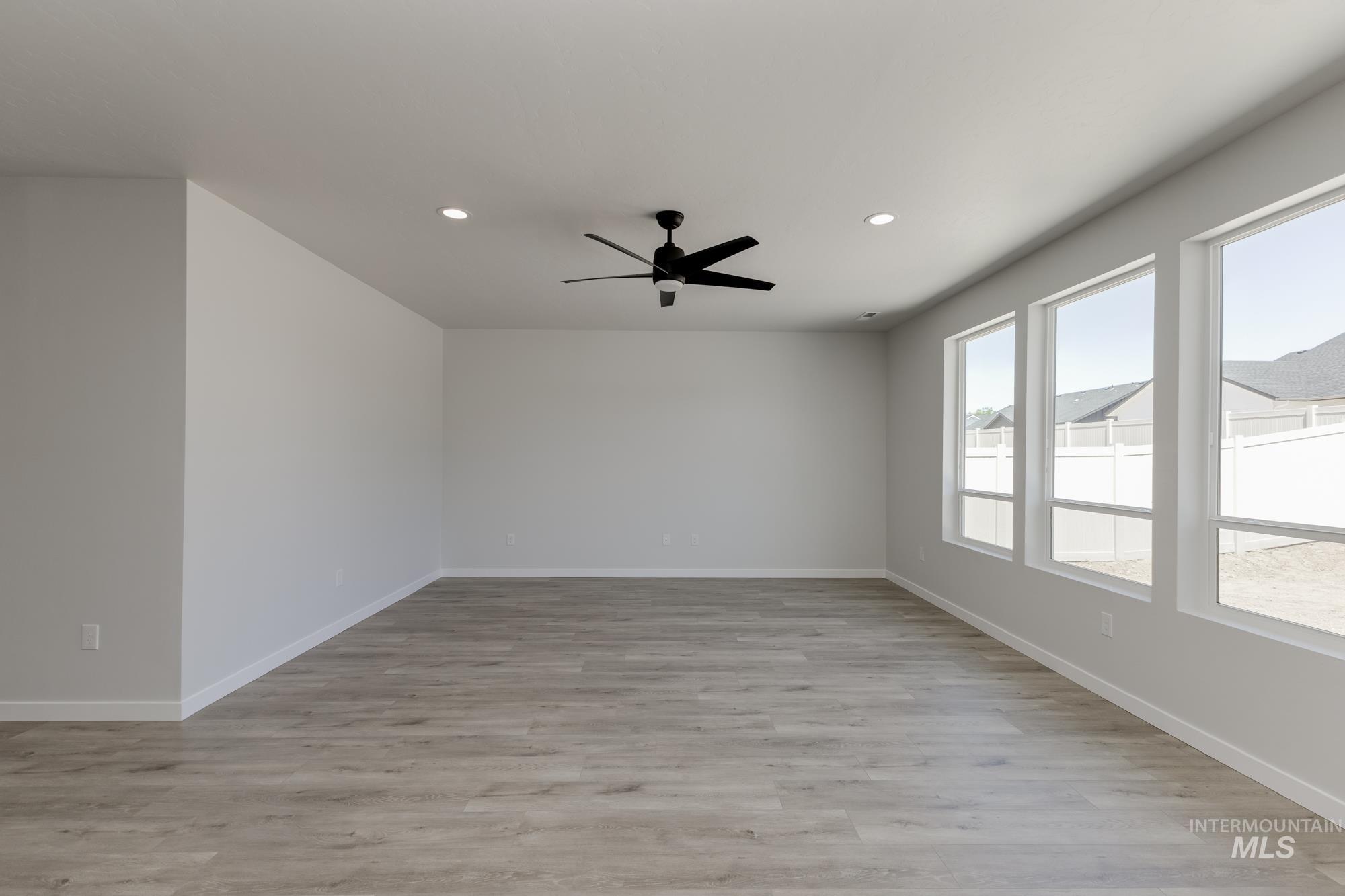 Empty room with recessed lighting, ceiling fan, and light wood-style floors
