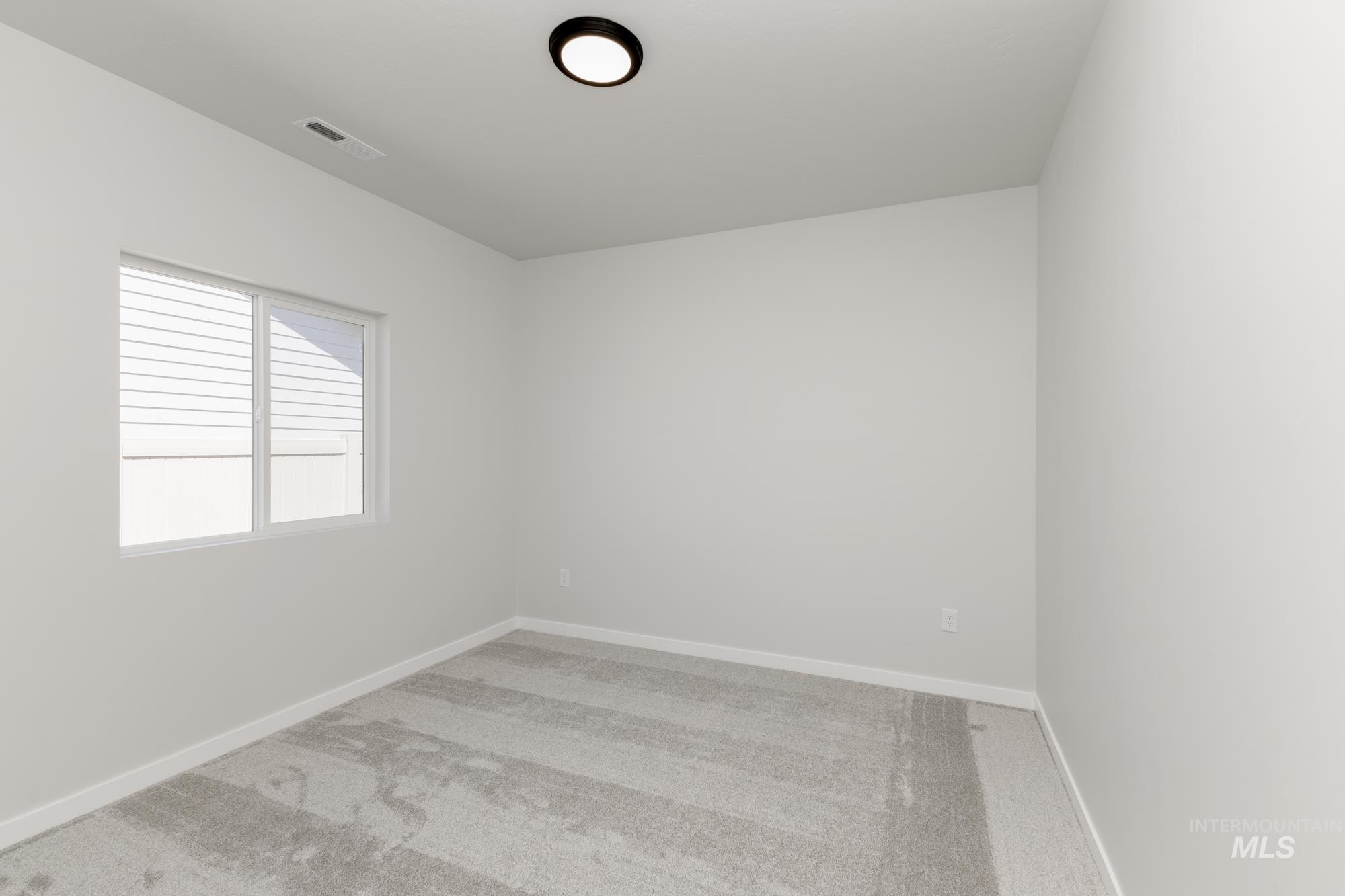 Unfurnished room featuring light carpet