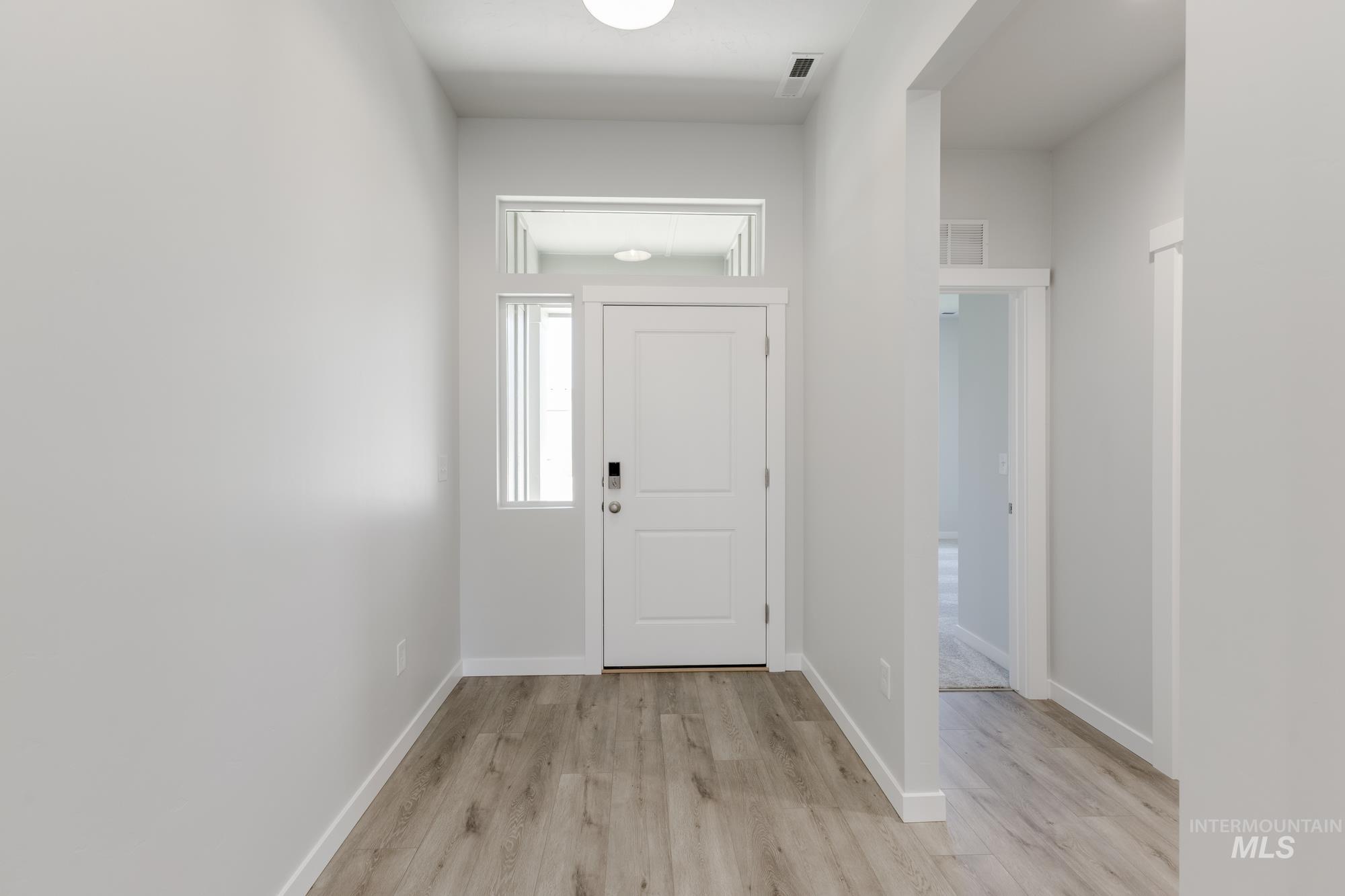 Entryway featuring light wood-style flooring and baseboards
