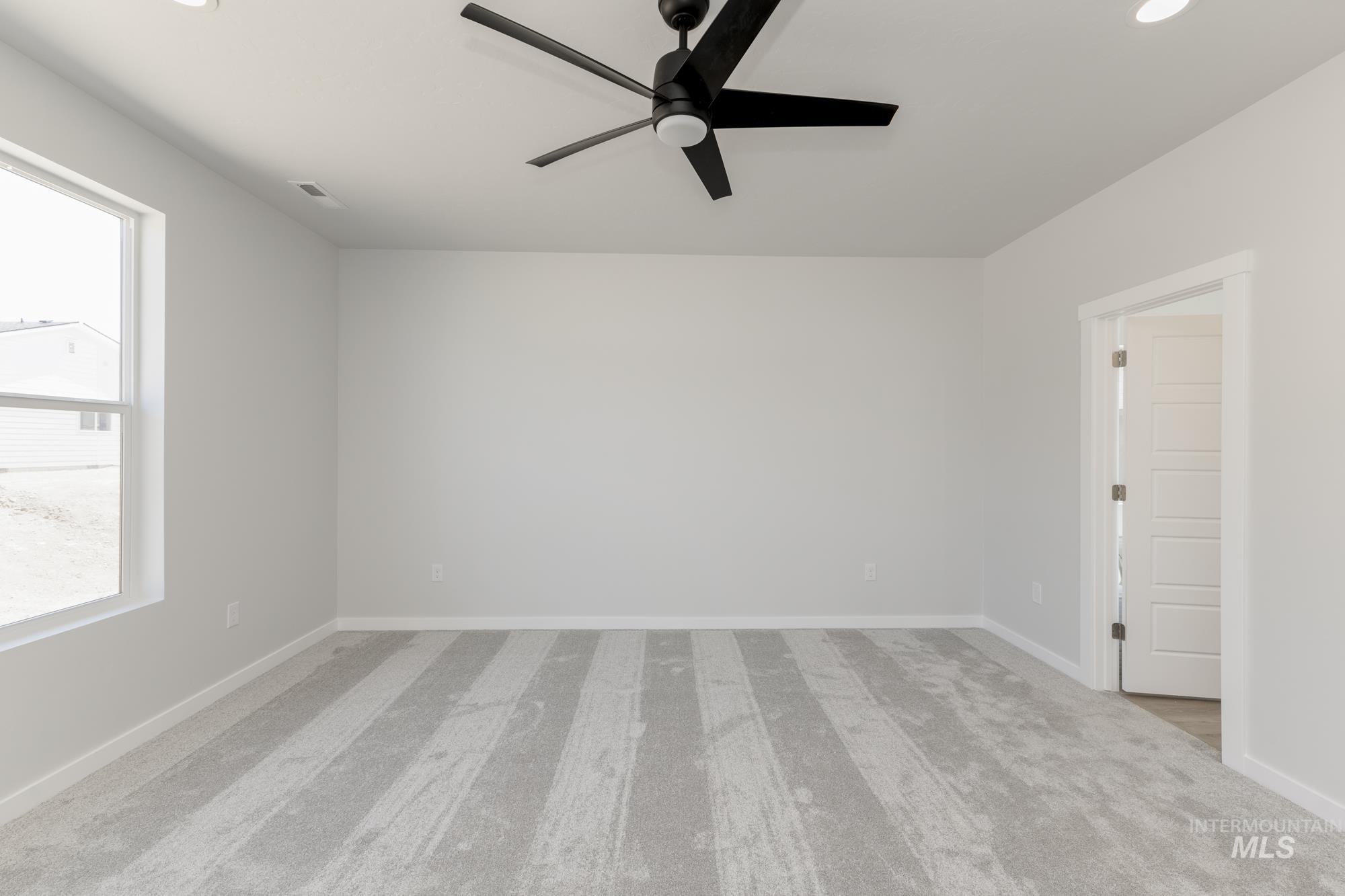 Unfurnished room with a ceiling fan, light carpet, healthy amount of natural light, and recessed lighting