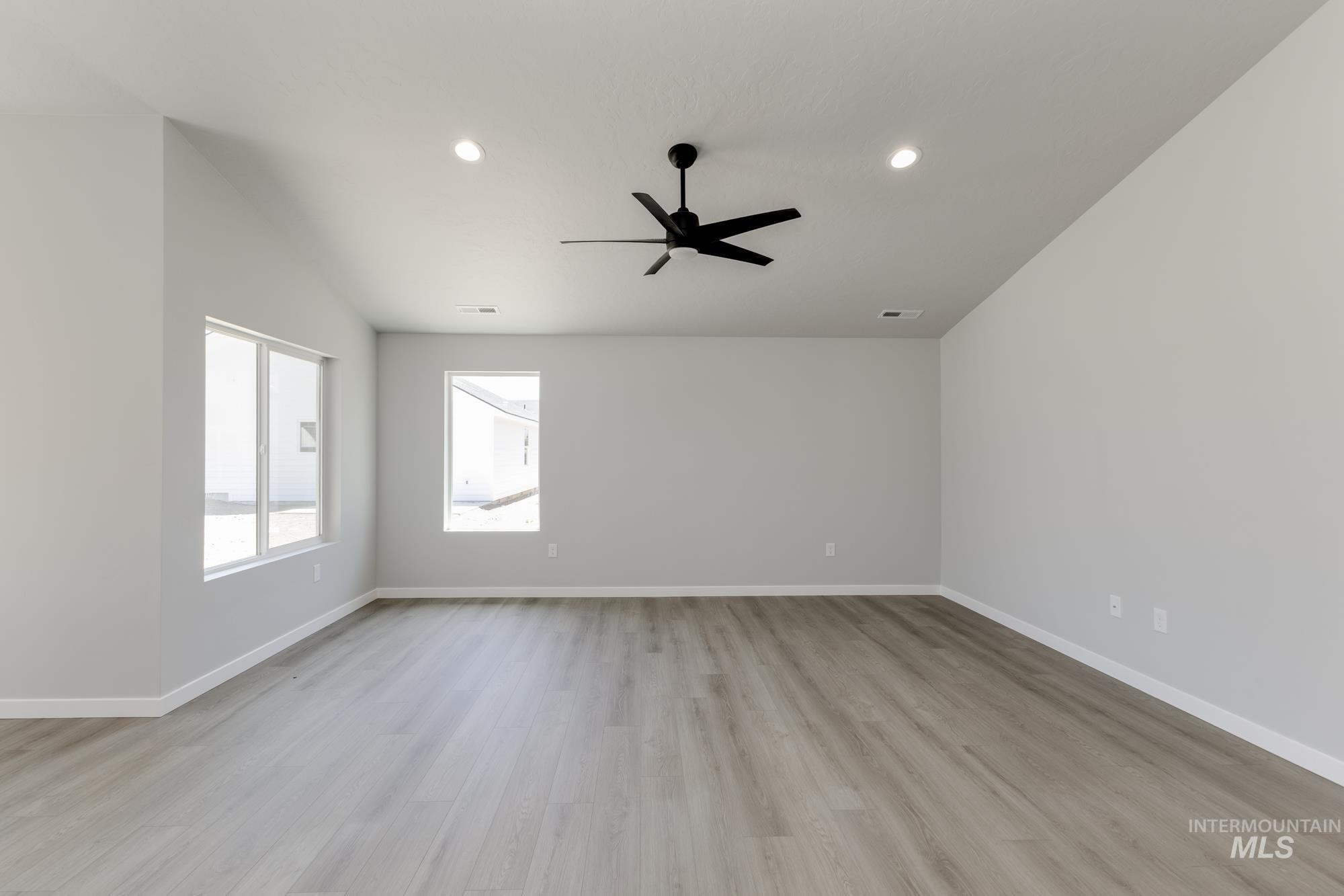 Empty room with light wood finished floors, recessed lighting, and ceiling fan