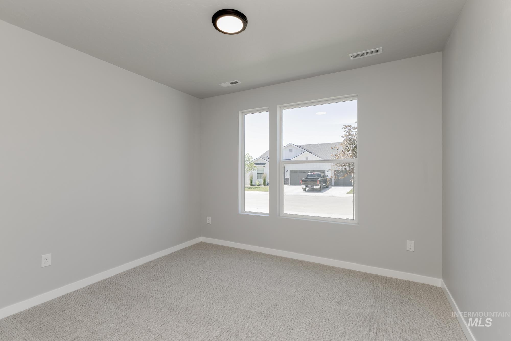Unfurnished room with light carpet and baseboards