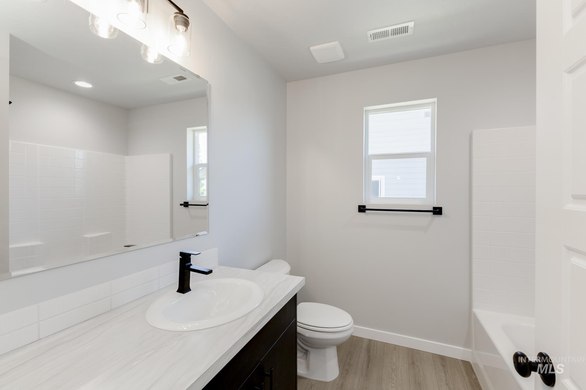 Bathroom featuring vanity and wood finished floors