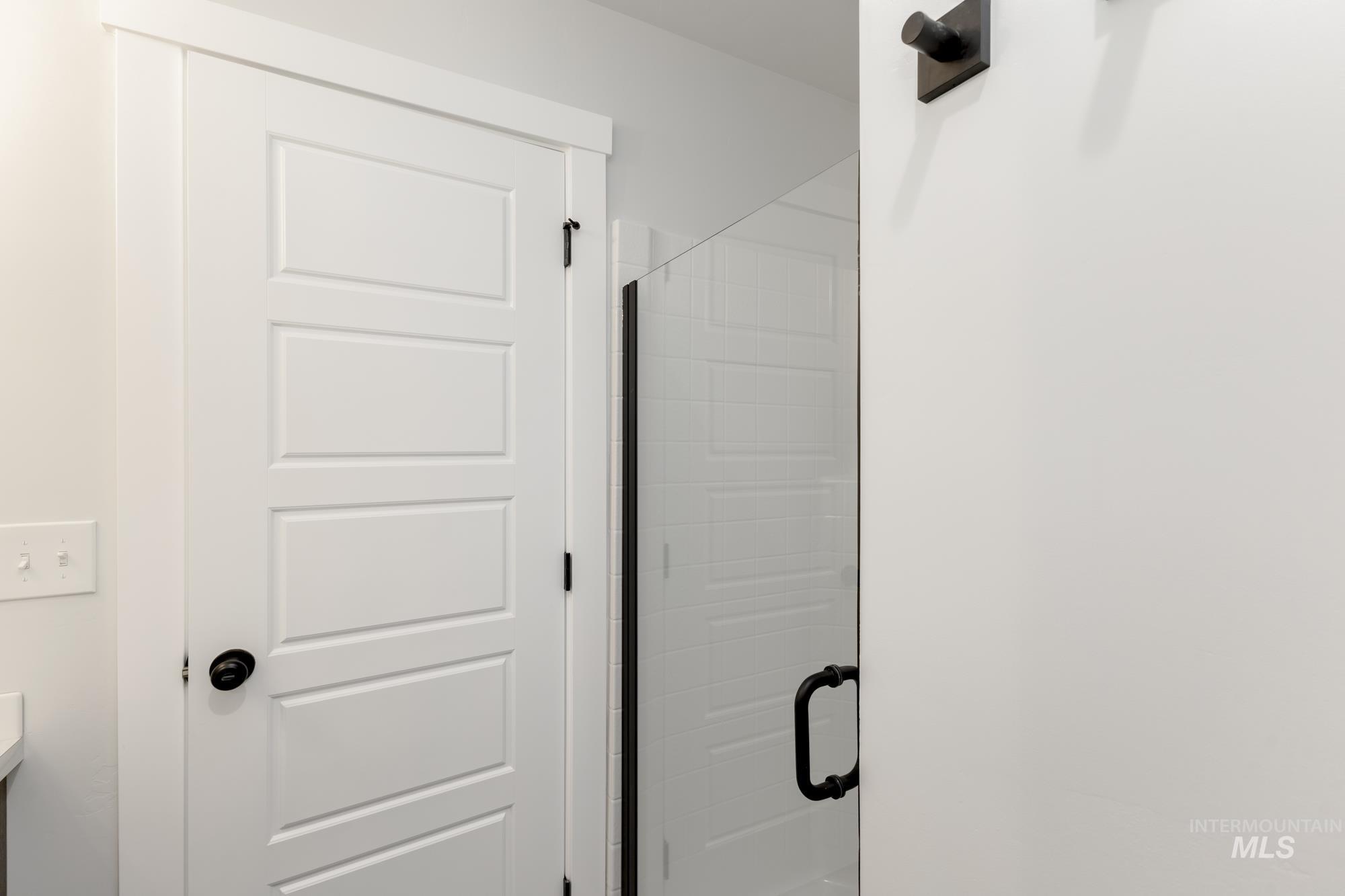 Full bathroom featuring a stall shower and vanity