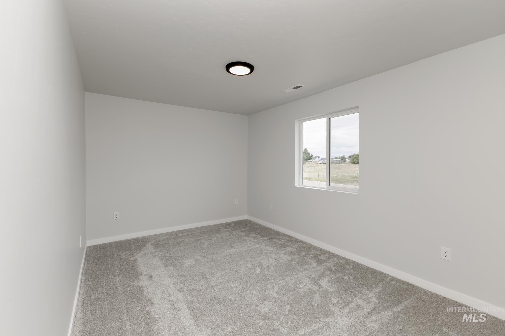 Unfurnished room with carpet floors