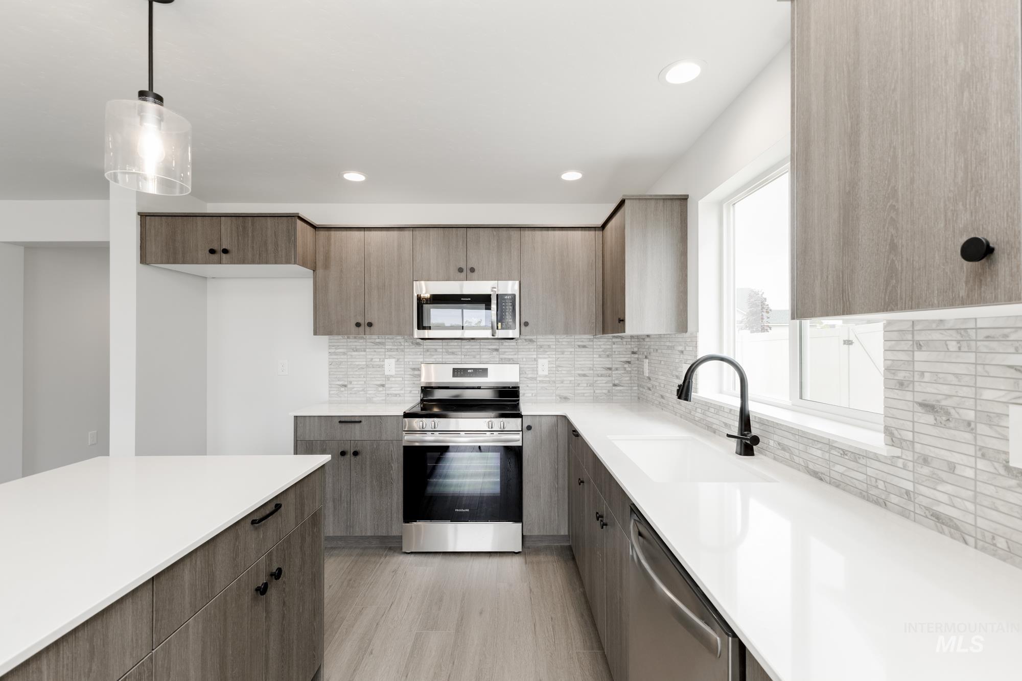 Kitchen with appliances with stainless steel finishes, modern cabinets, and recessed lighting