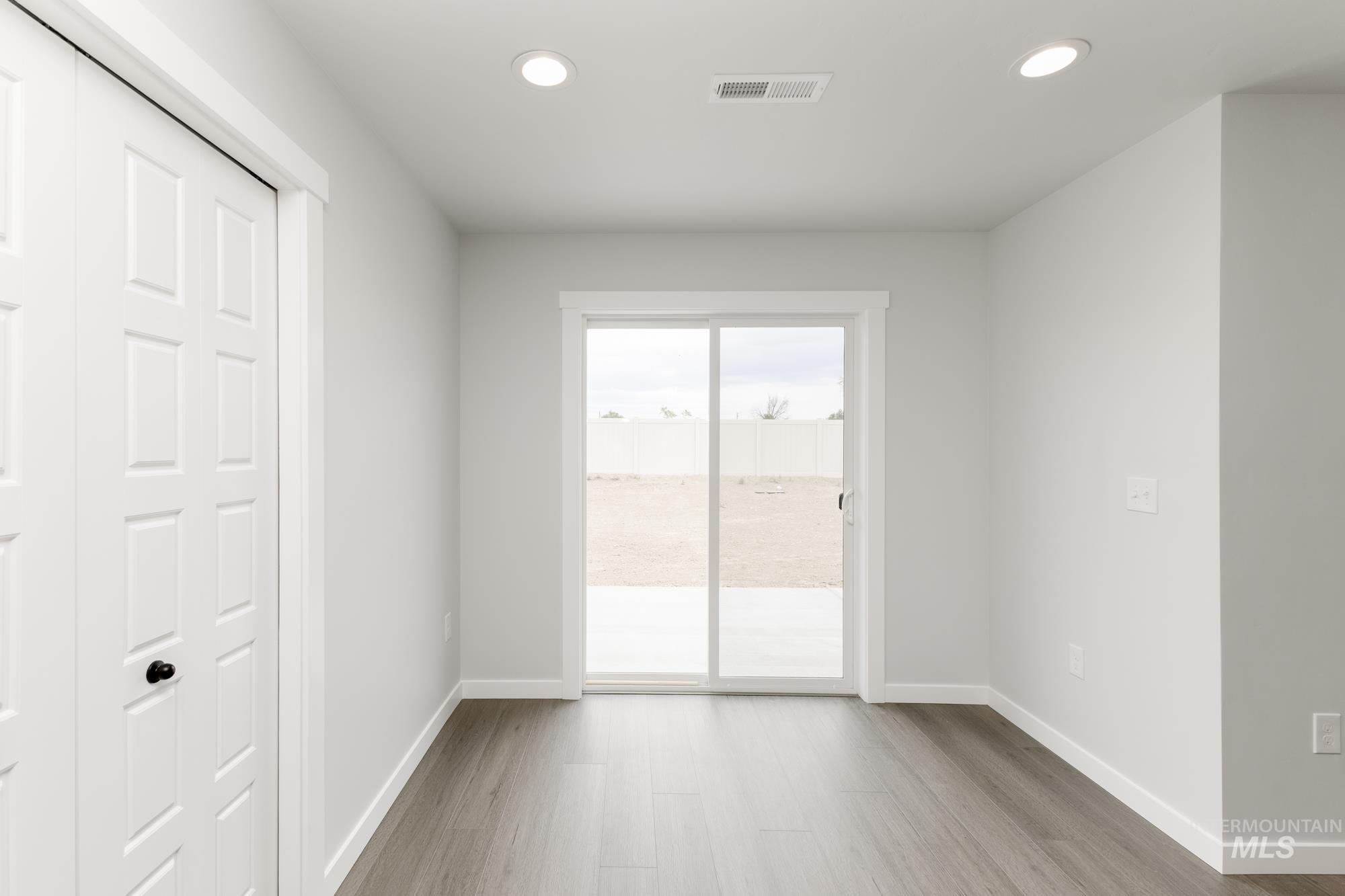 Unfurnished room featuring wood finished floors and recessed lighting