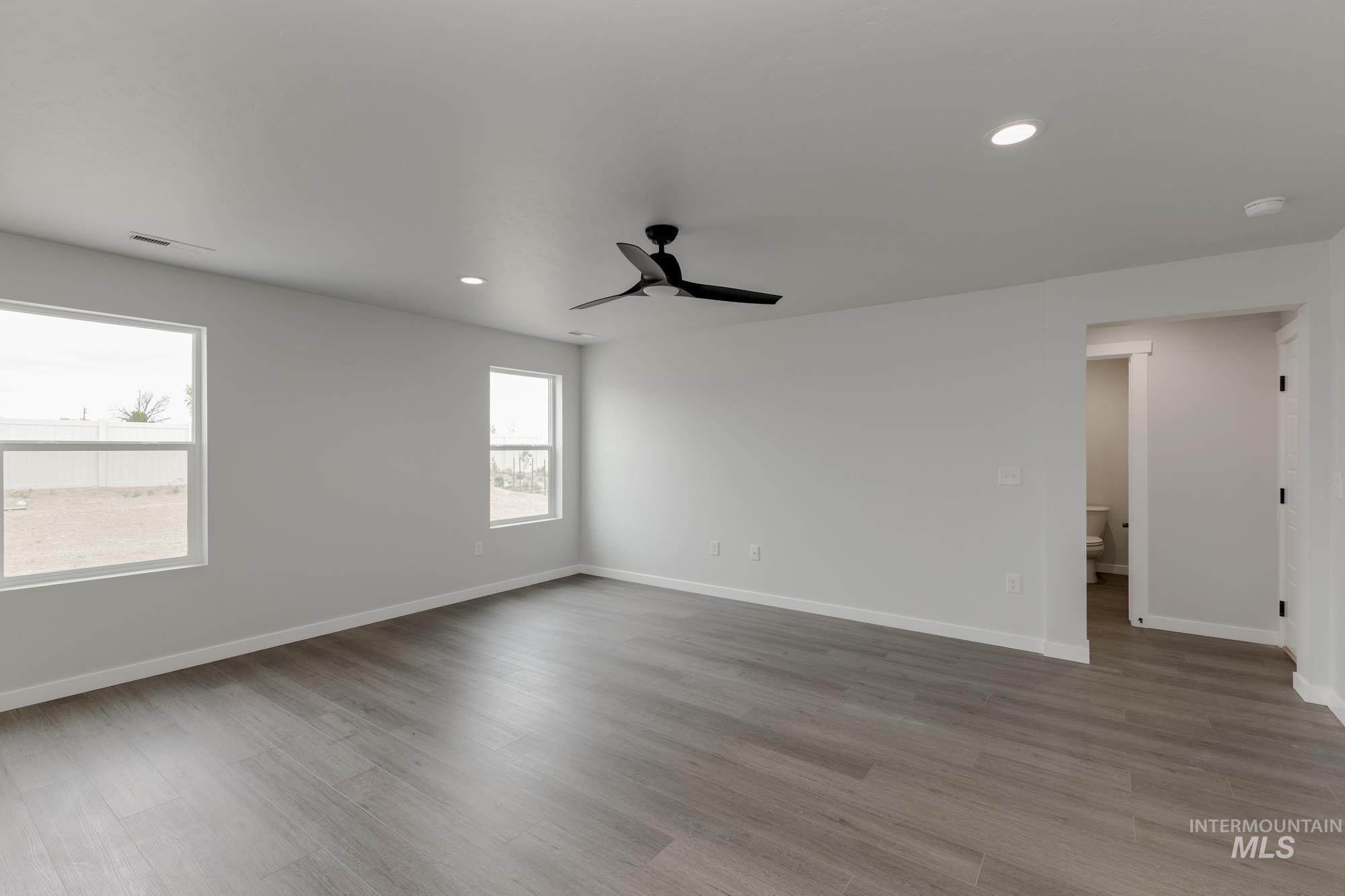 Spare room featuring ceiling fan, wood finished floors, recessed lighting, and a smoke detector