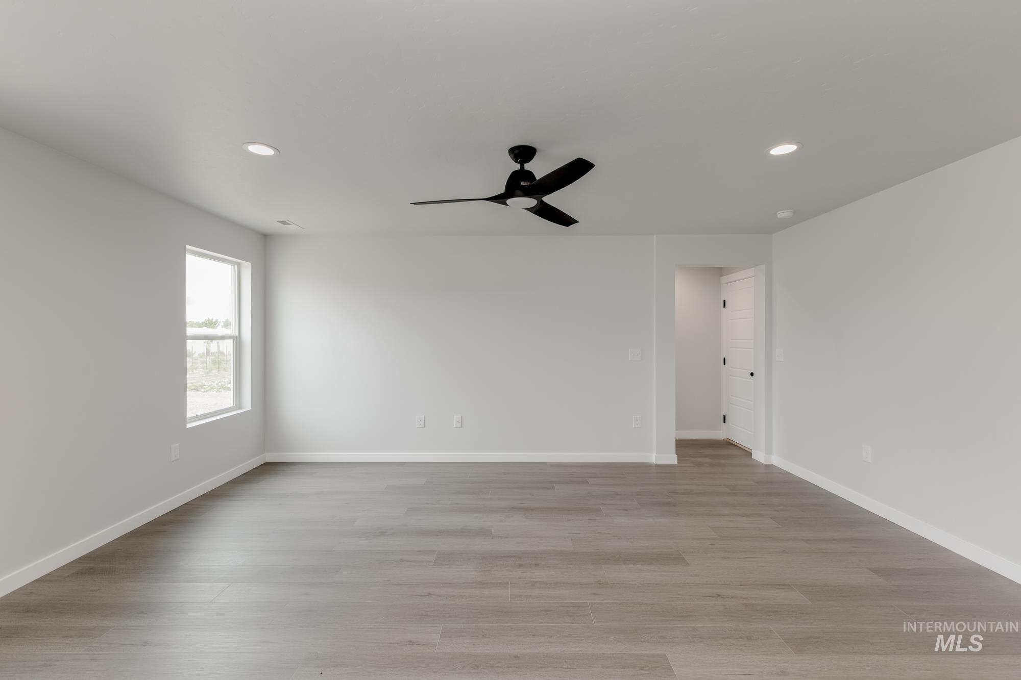Spare room featuring a ceiling fan, recessed lighting, and light wood finished floors