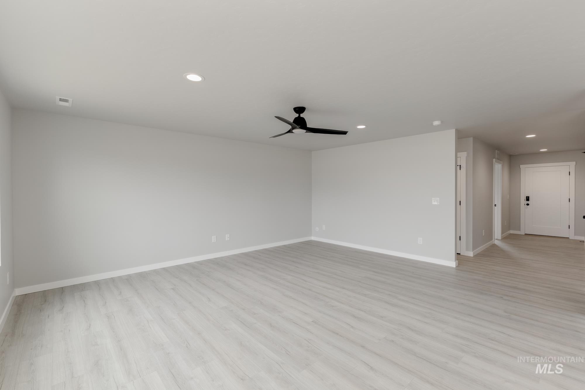 Empty room featuring recessed lighting, ceiling fan, and light wood finished floors