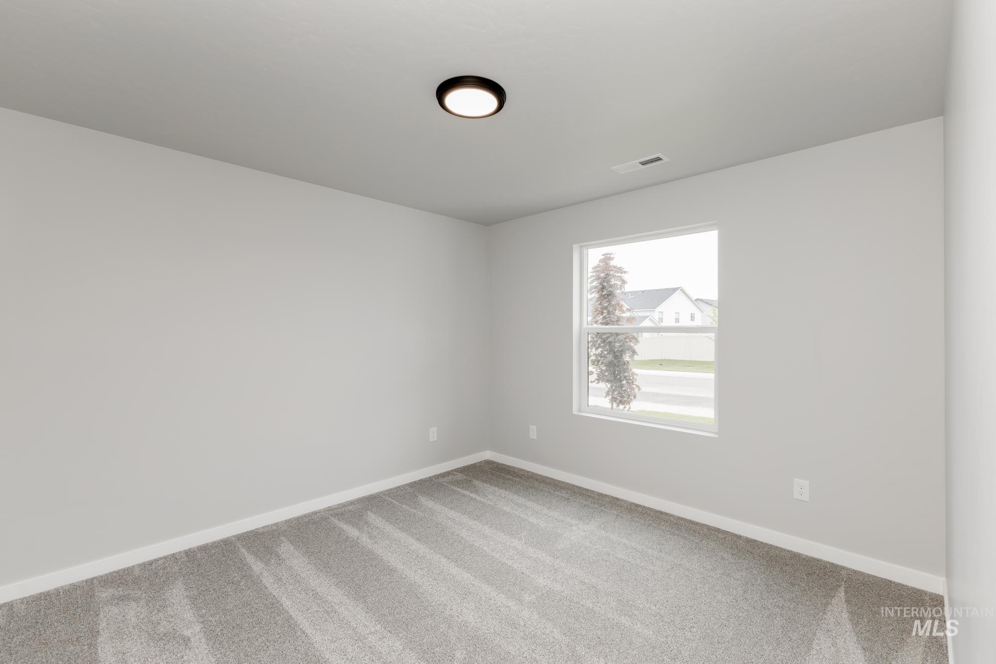 Empty room featuring carpet flooring