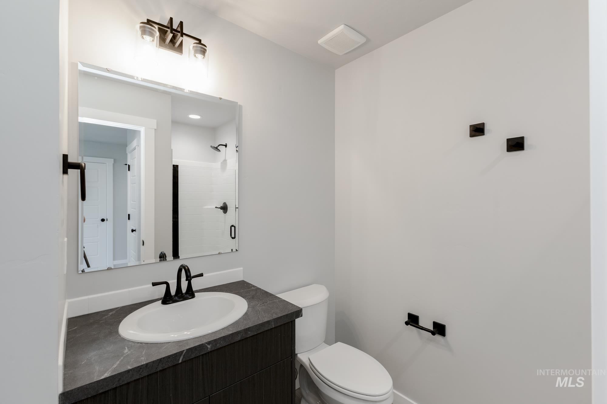 Bathroom with vanity and a shower