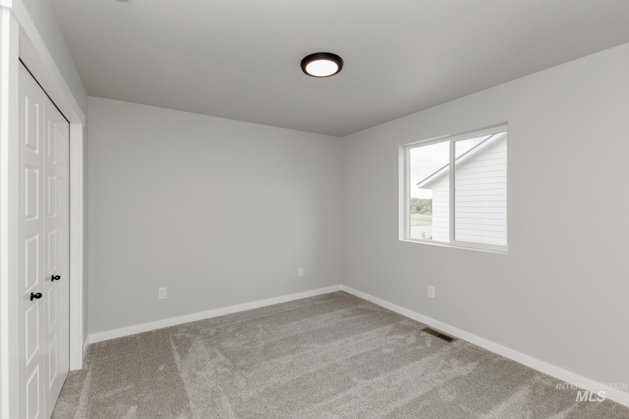Unfurnished bedroom featuring carpet flooring and a closet