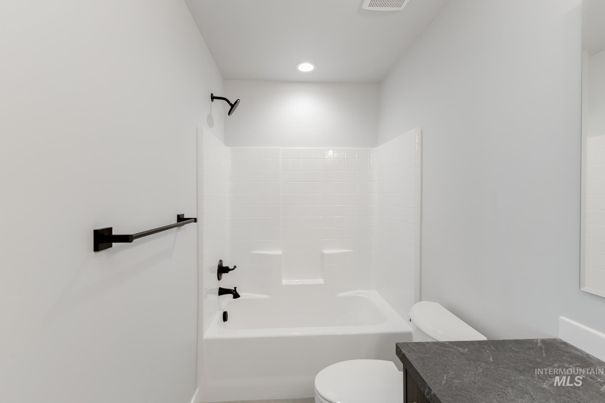 Bathroom with vanity and bathing tub / shower combination