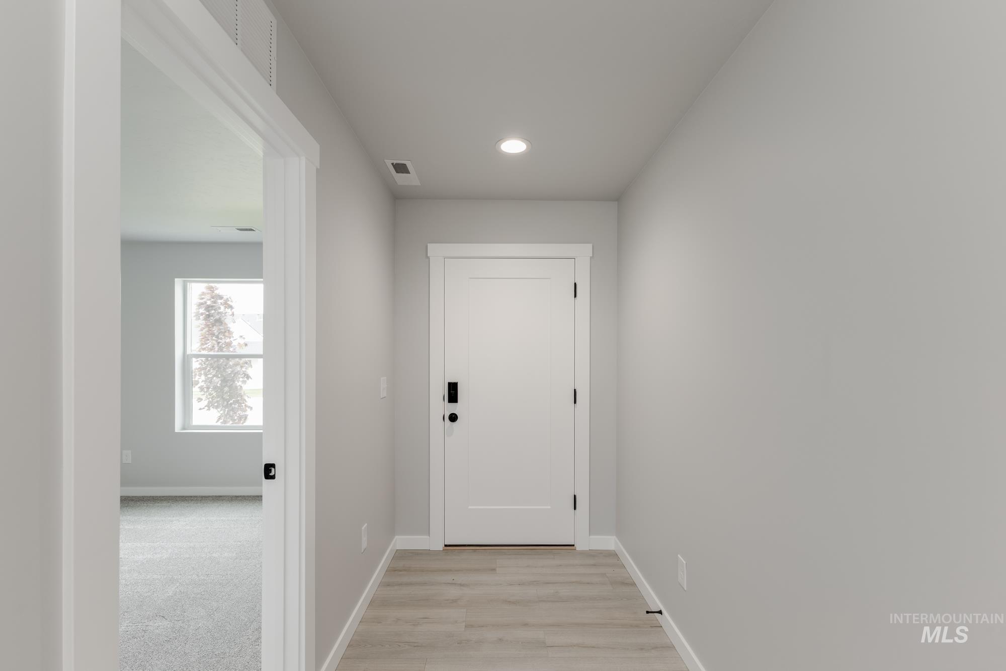 Doorway featuring recessed lighting and light wood-style flooring