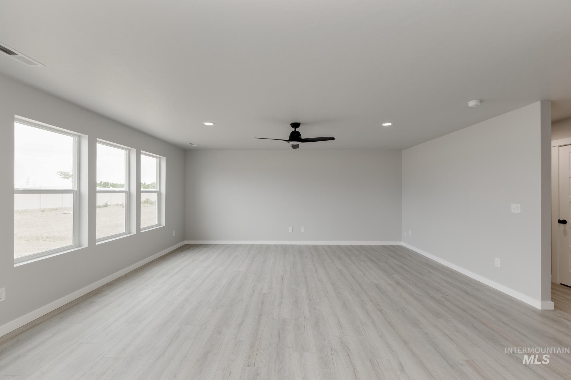 Spare room featuring recessed lighting, light wood finished floors, ceiling fan, and a smoke detector