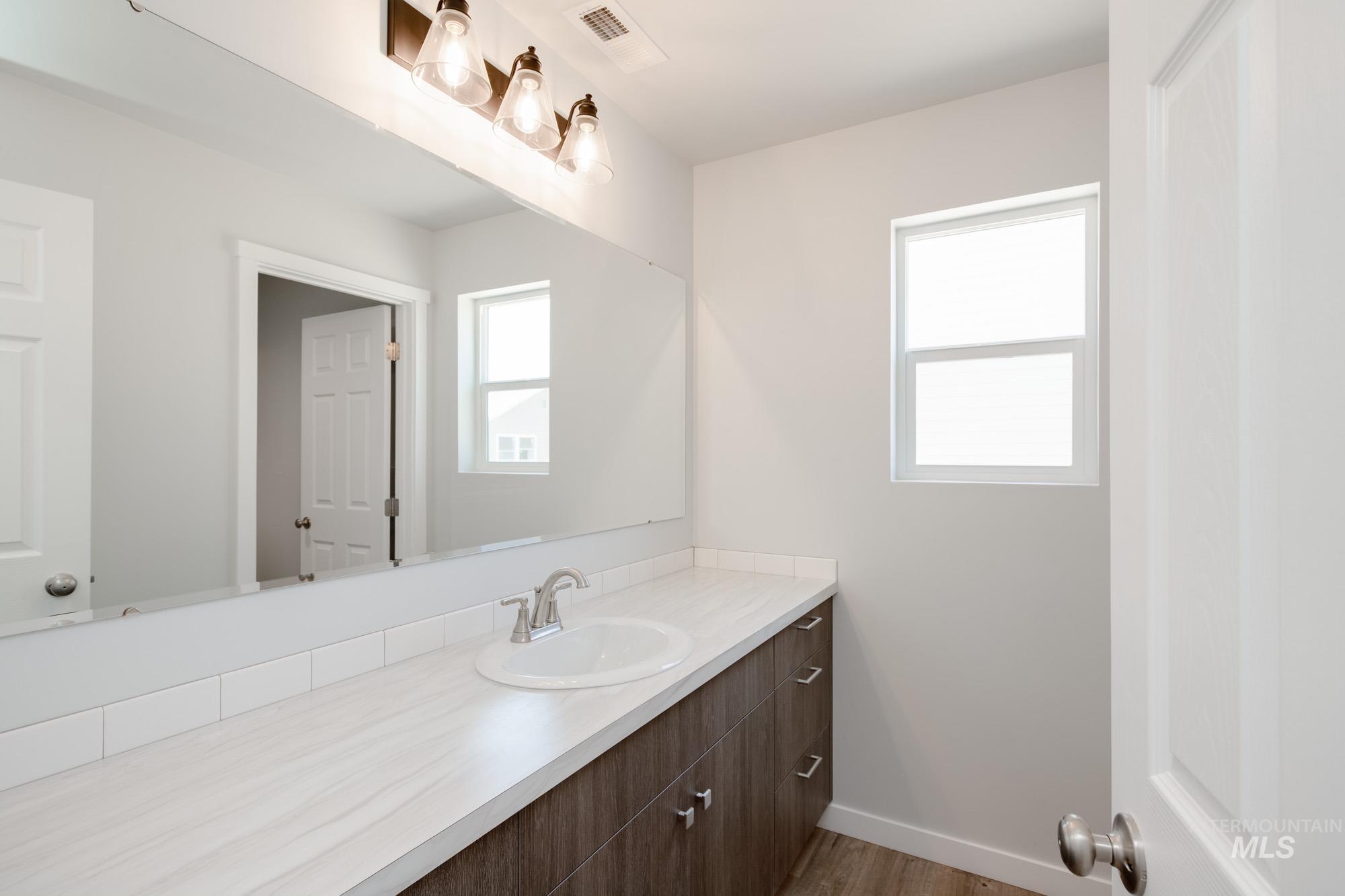 Bathroom featuring vanity and wood finished floors