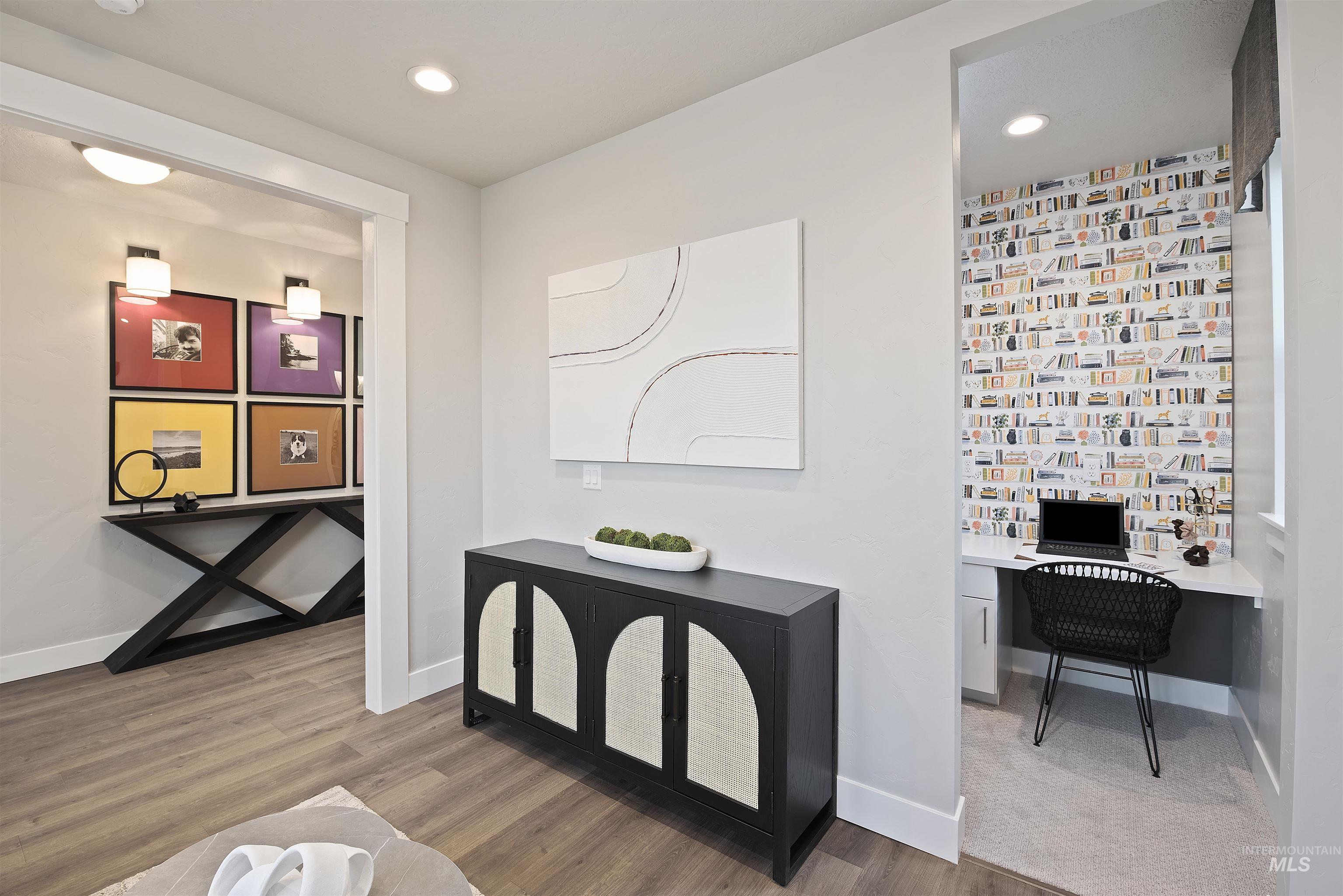 Interior space with built in study area, recessed lighting, and wood finished floors