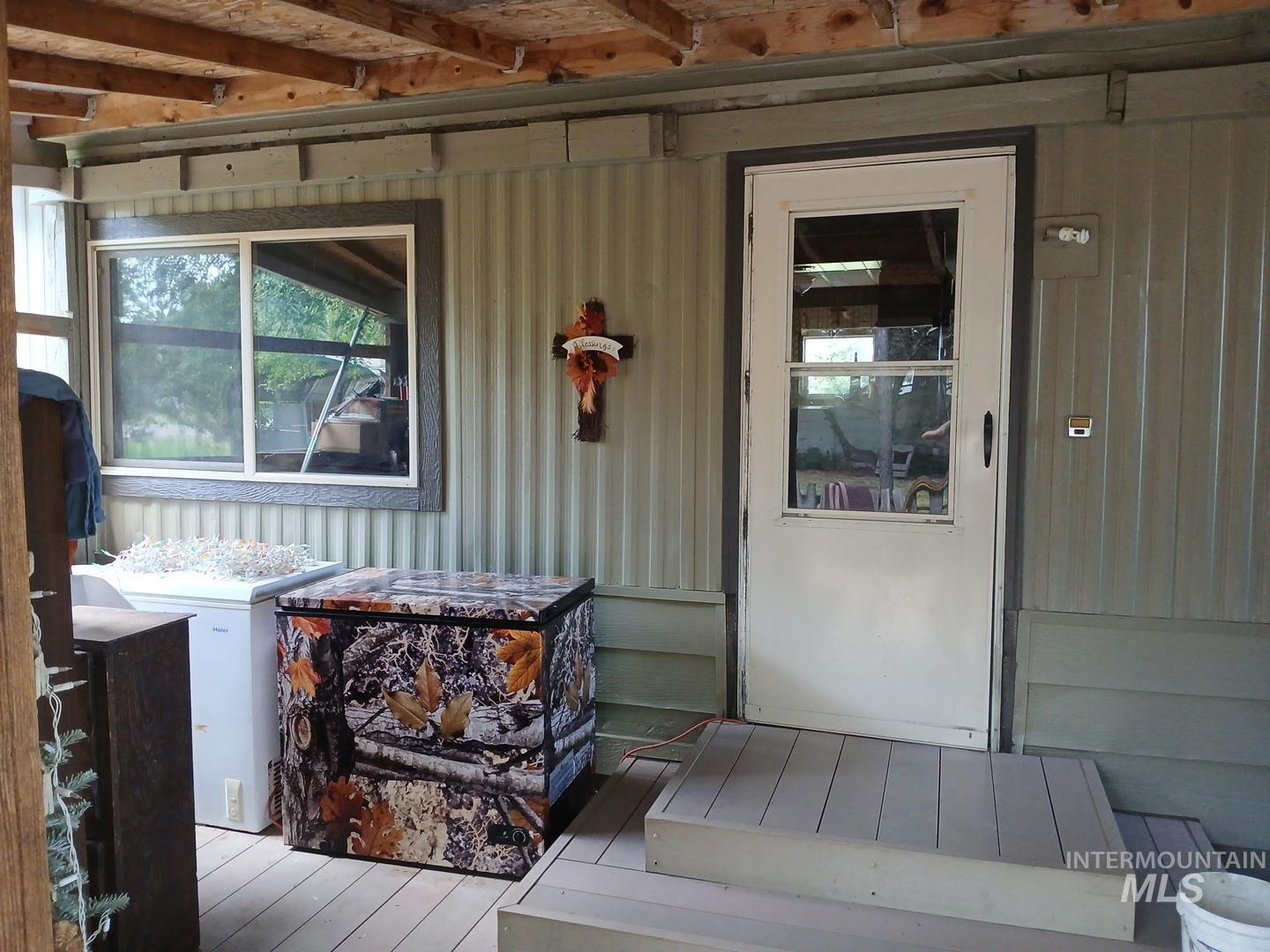 Entrance to property featuring a deck