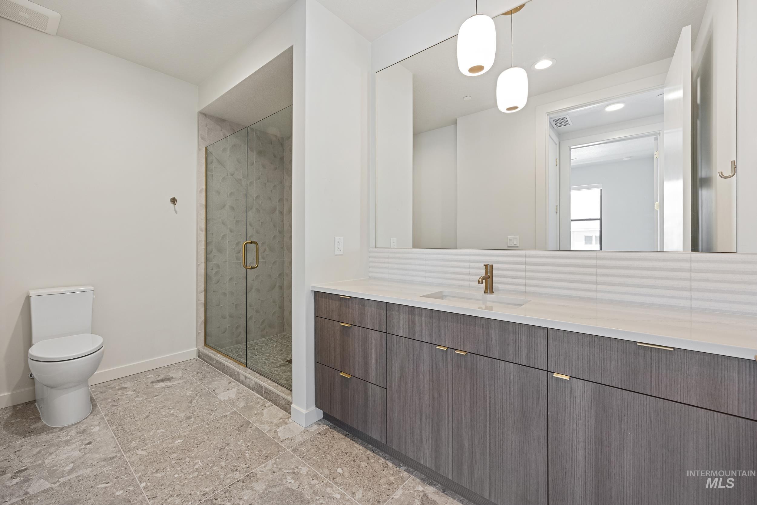 Full bath with vanity, a marble finish shower, and recessed lighting
