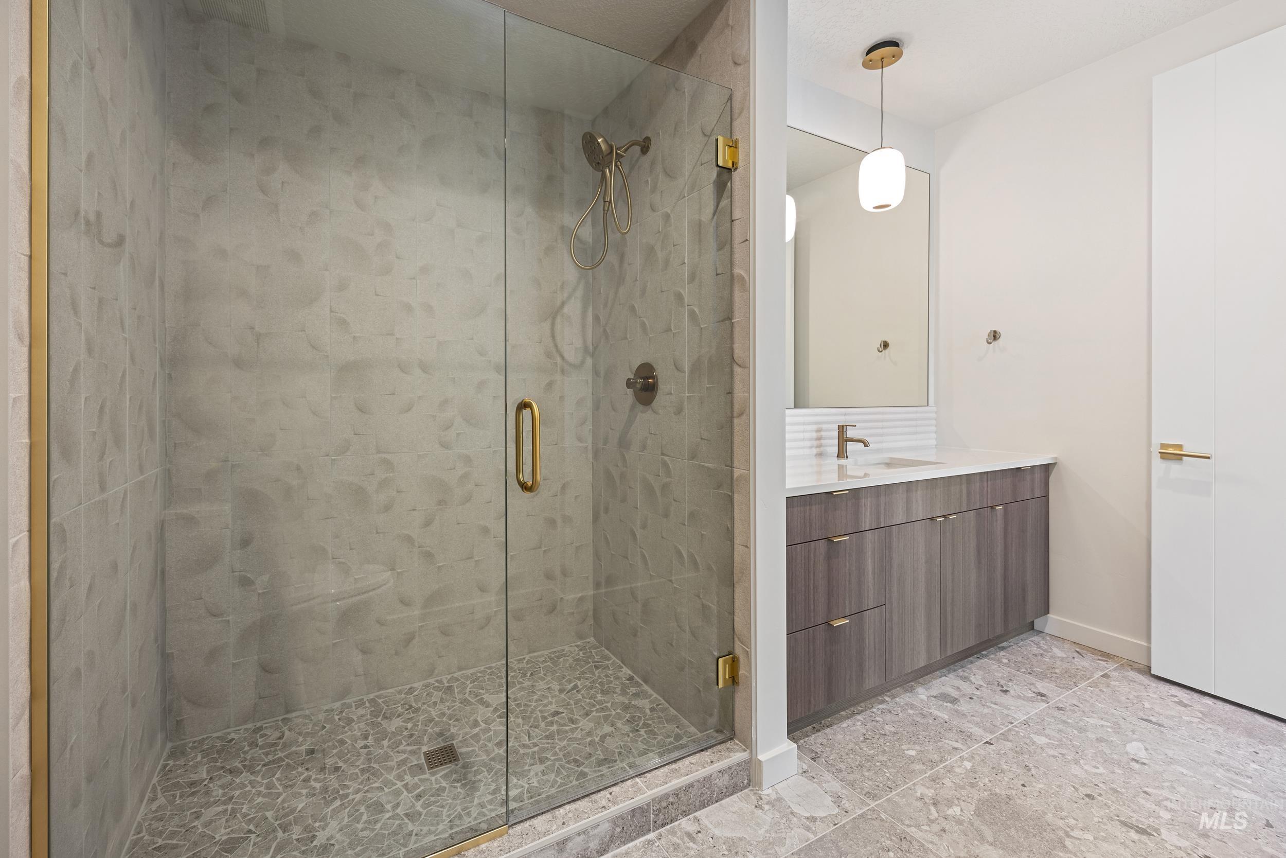 Bathroom featuring vanity and a shower stall