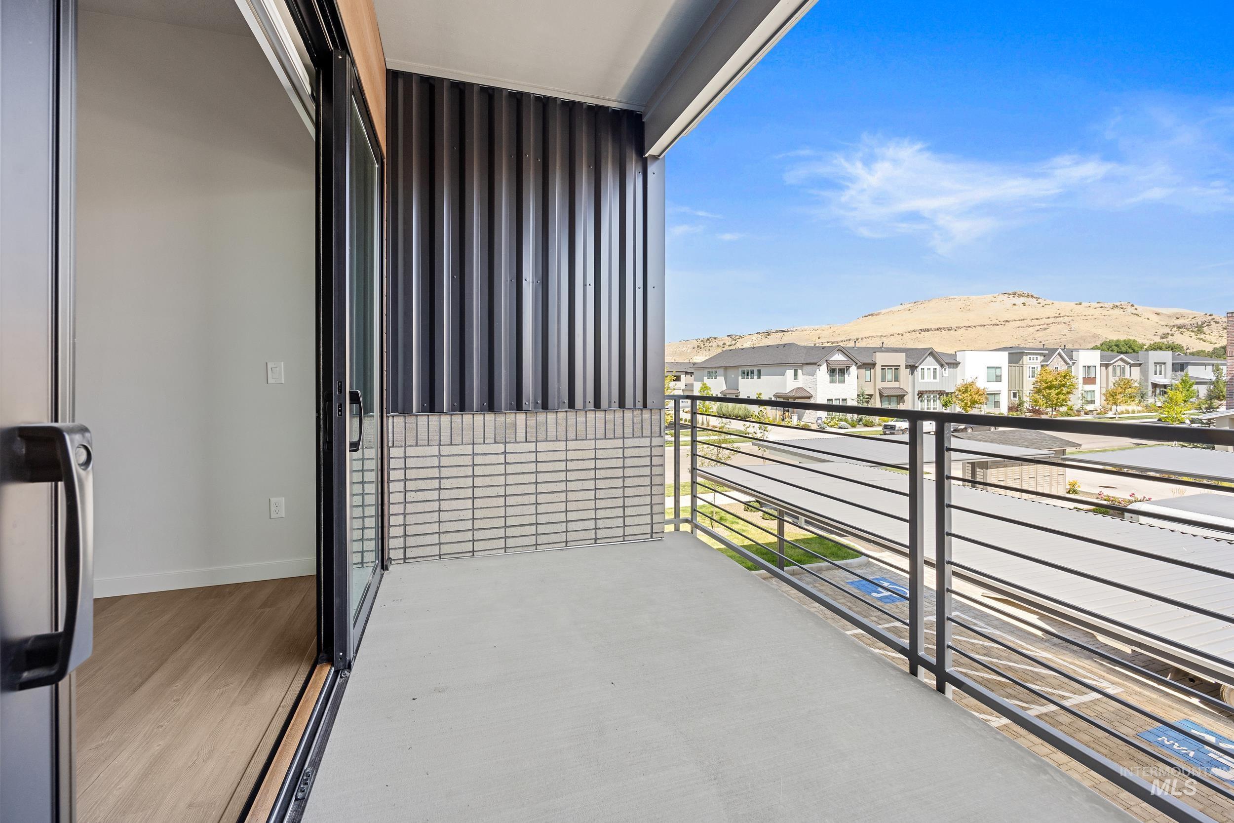 Balcony featuring a mountain view and a residential view