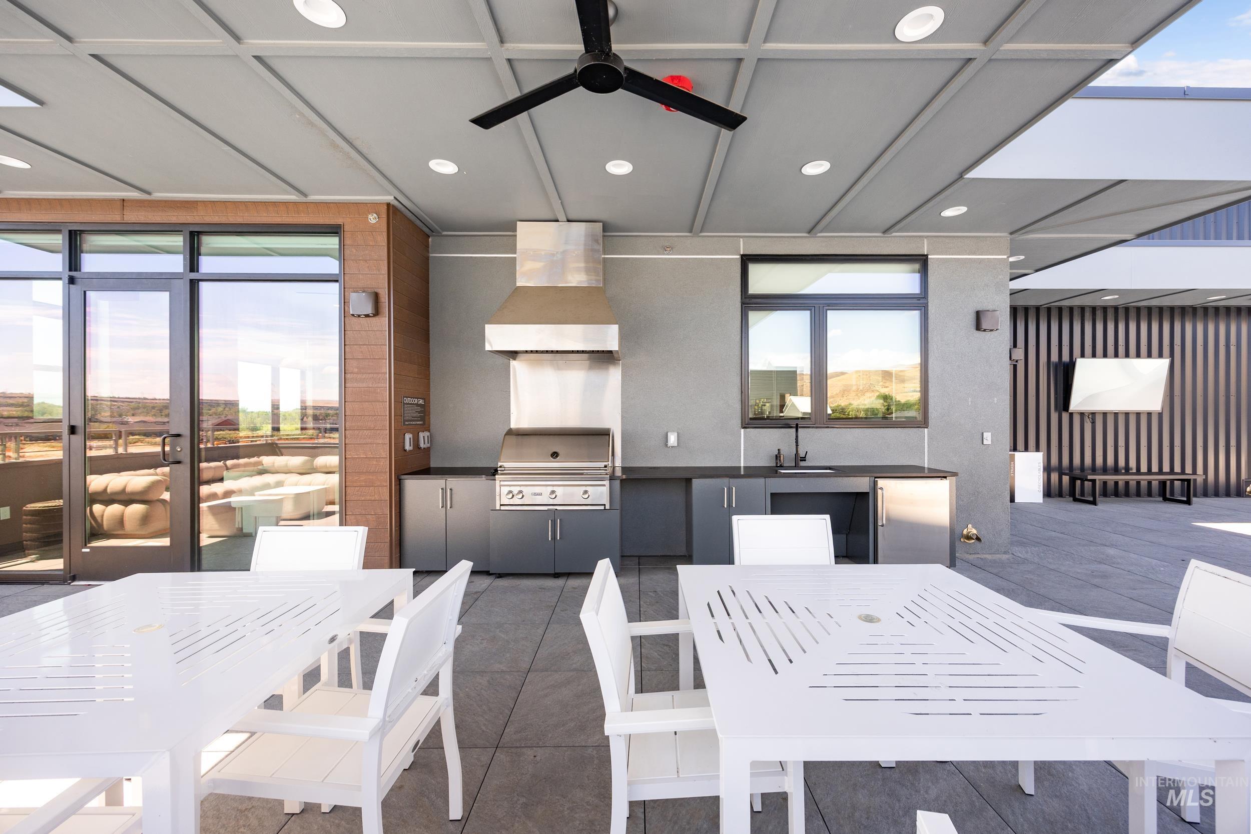 Dining space with a ceiling fan and recessed lighting