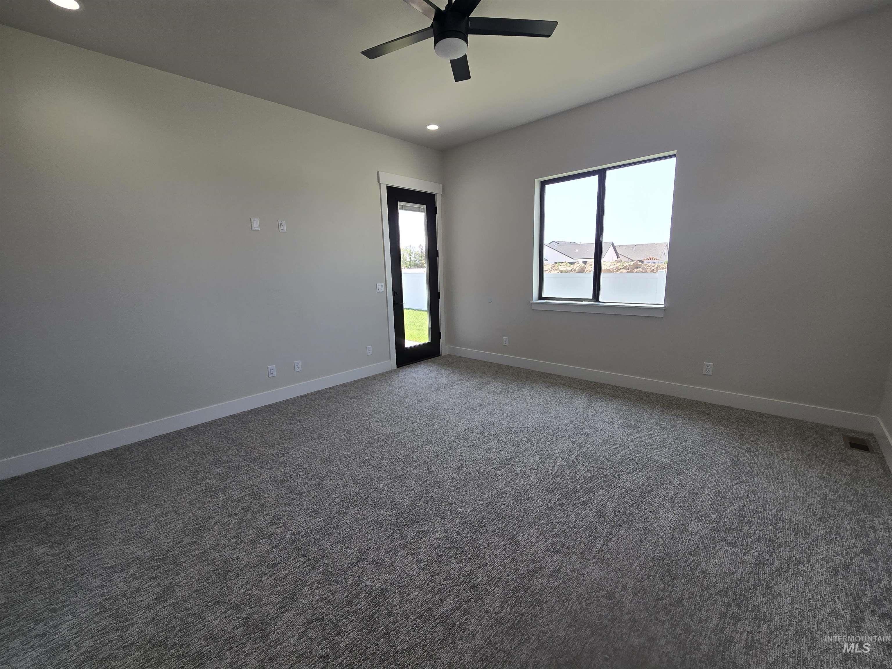 Unfurnished room with recessed lighting, a ceiling fan, and carpet