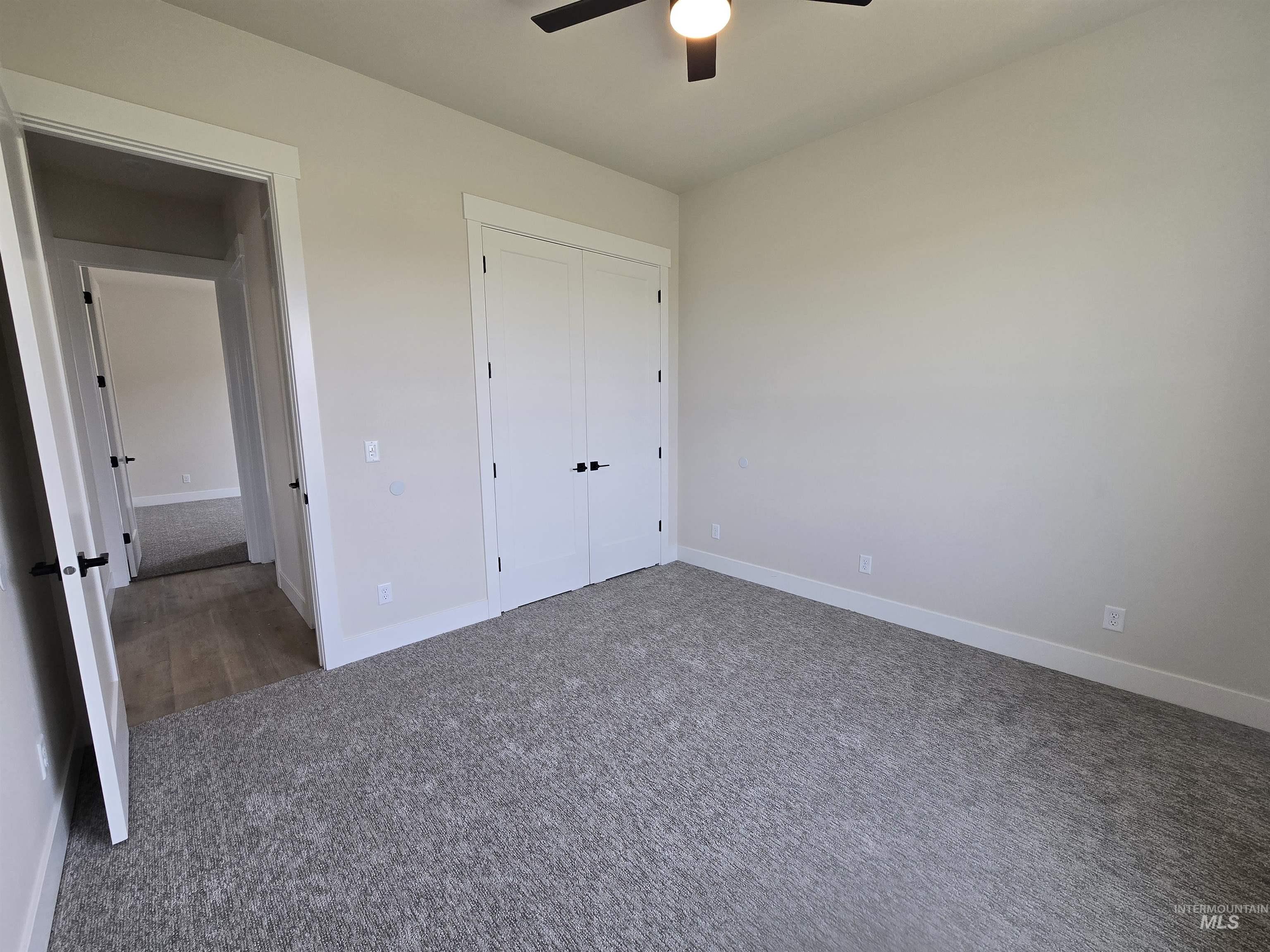 Unfurnished bedroom with carpet flooring, a closet, and ceiling fan