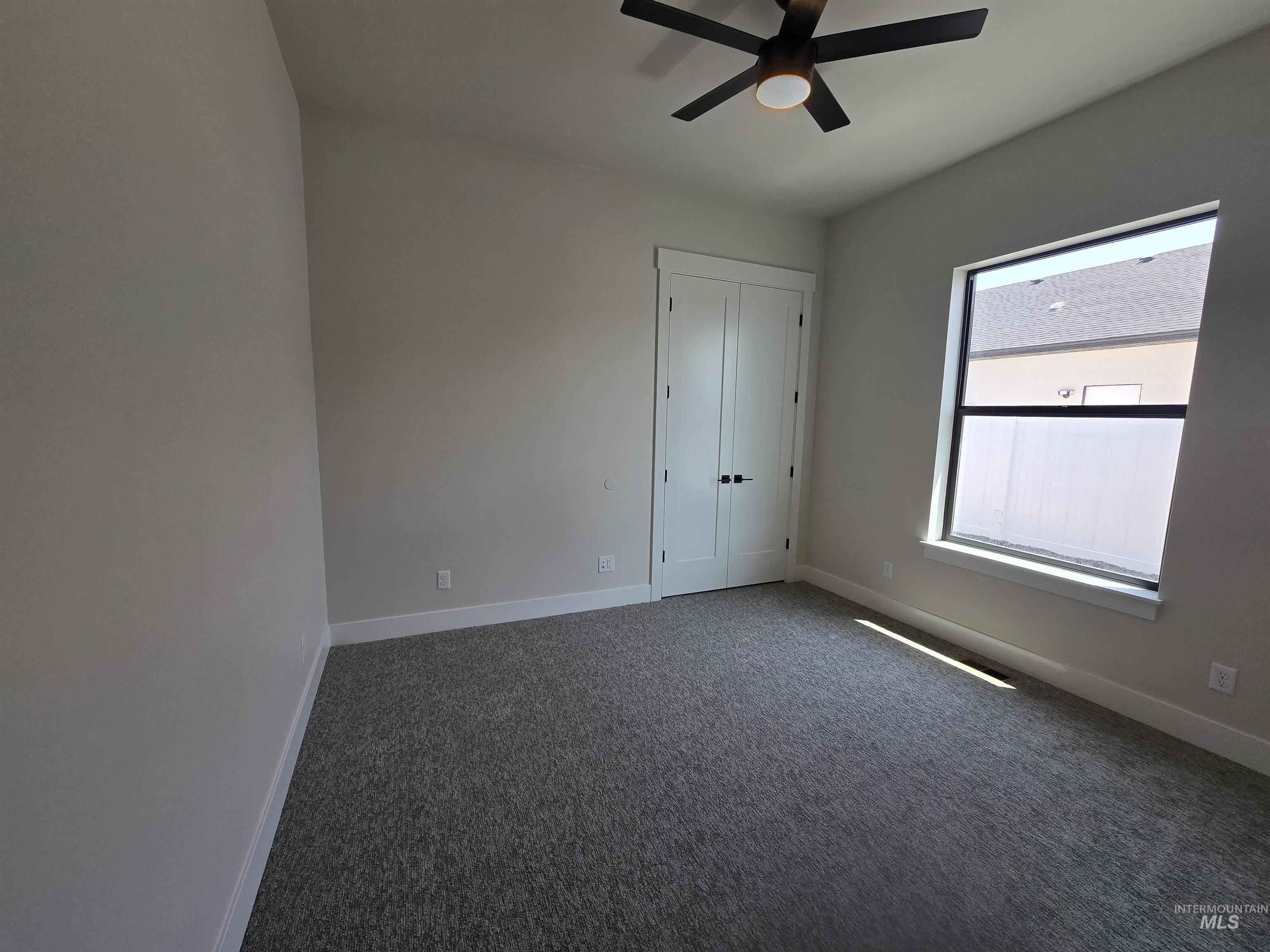 Unfurnished bedroom with carpet and ceiling fan